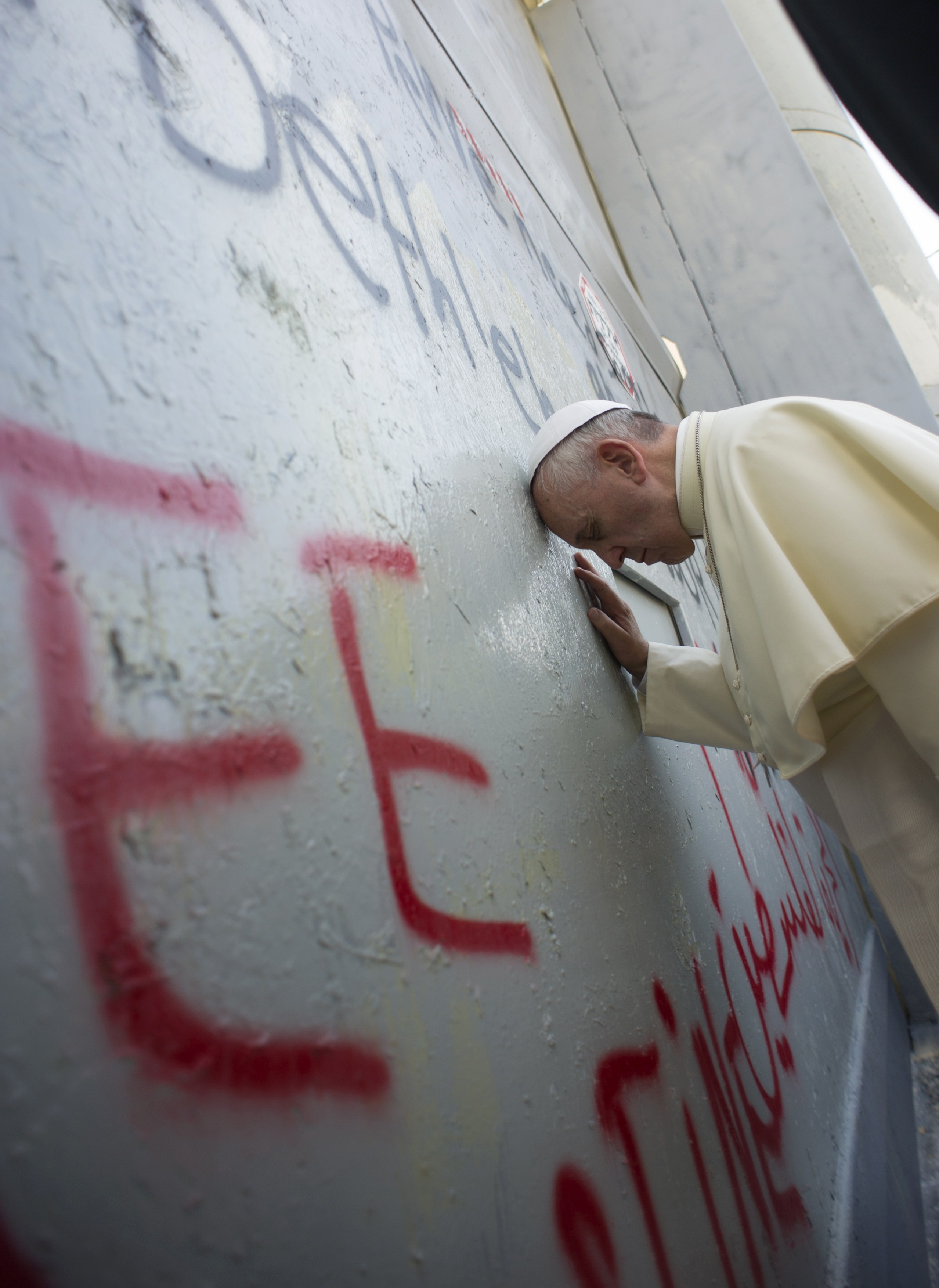 Pope Francis prayed Sunday at a concrete barrier separating Israel and the Palestinian territory during his Bethlehem visit.