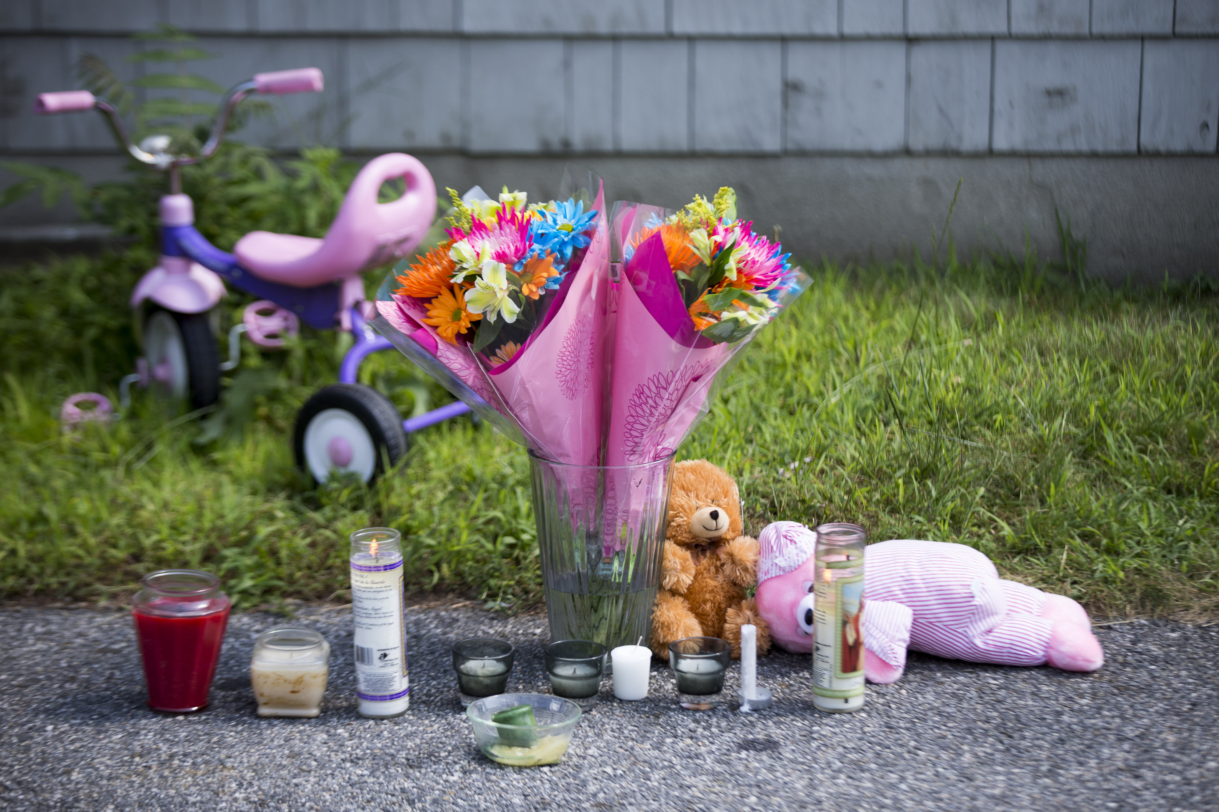 A memorial sat in front of the home where two children, one of whom died, were removed by paramedics in Auburn on Saturday.