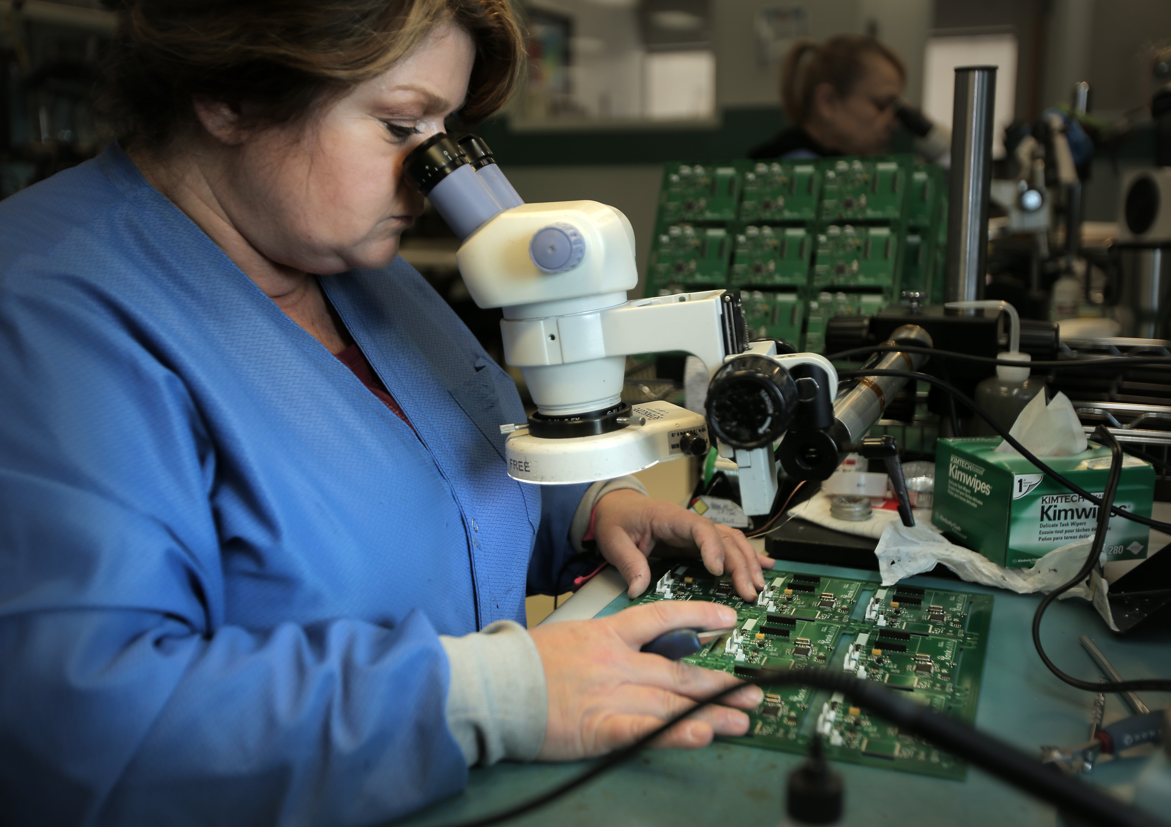 Joanne MacDonald inspected a circuit board at Lightspeed.