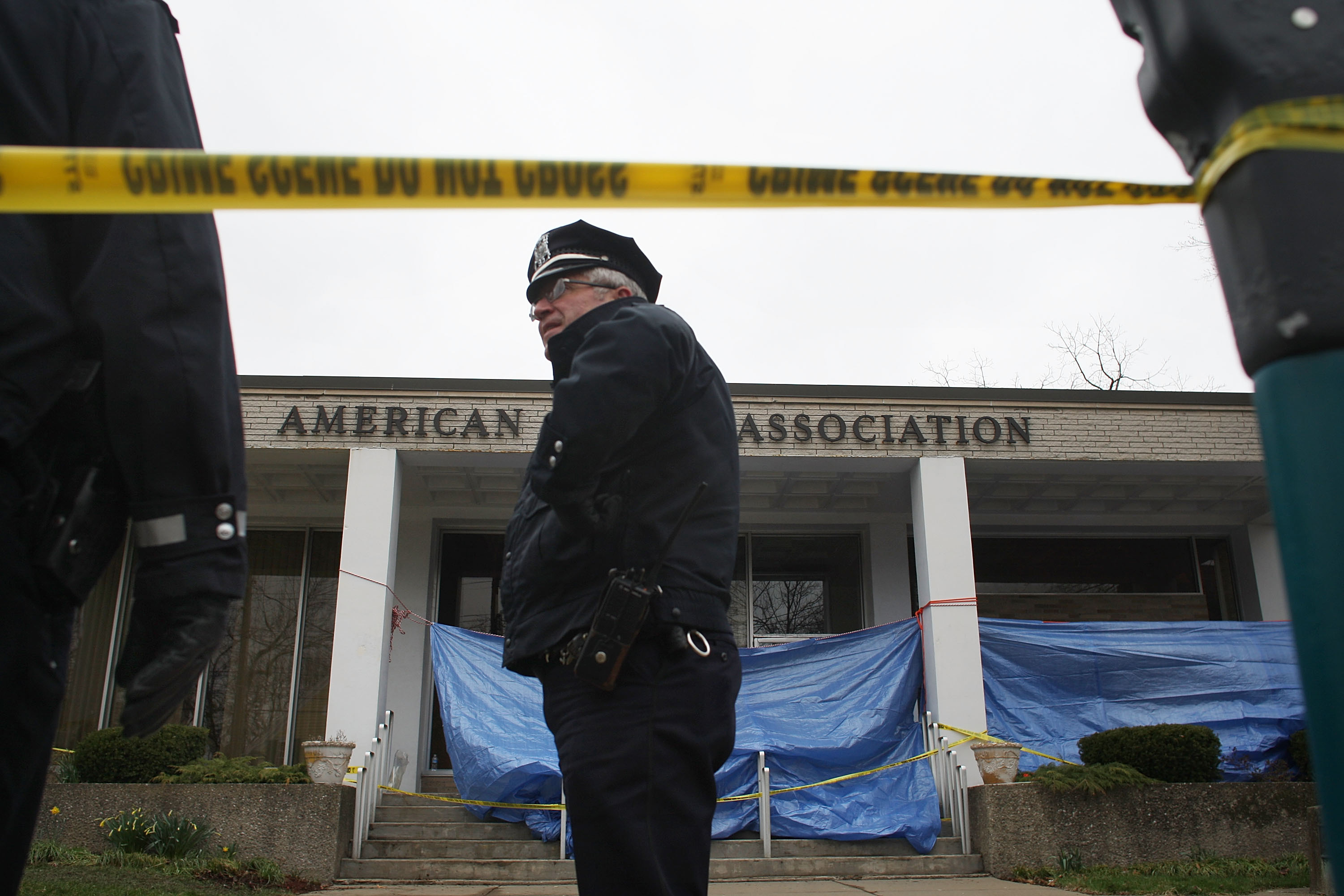 A police officer stood in front of the marked-off crime scene.