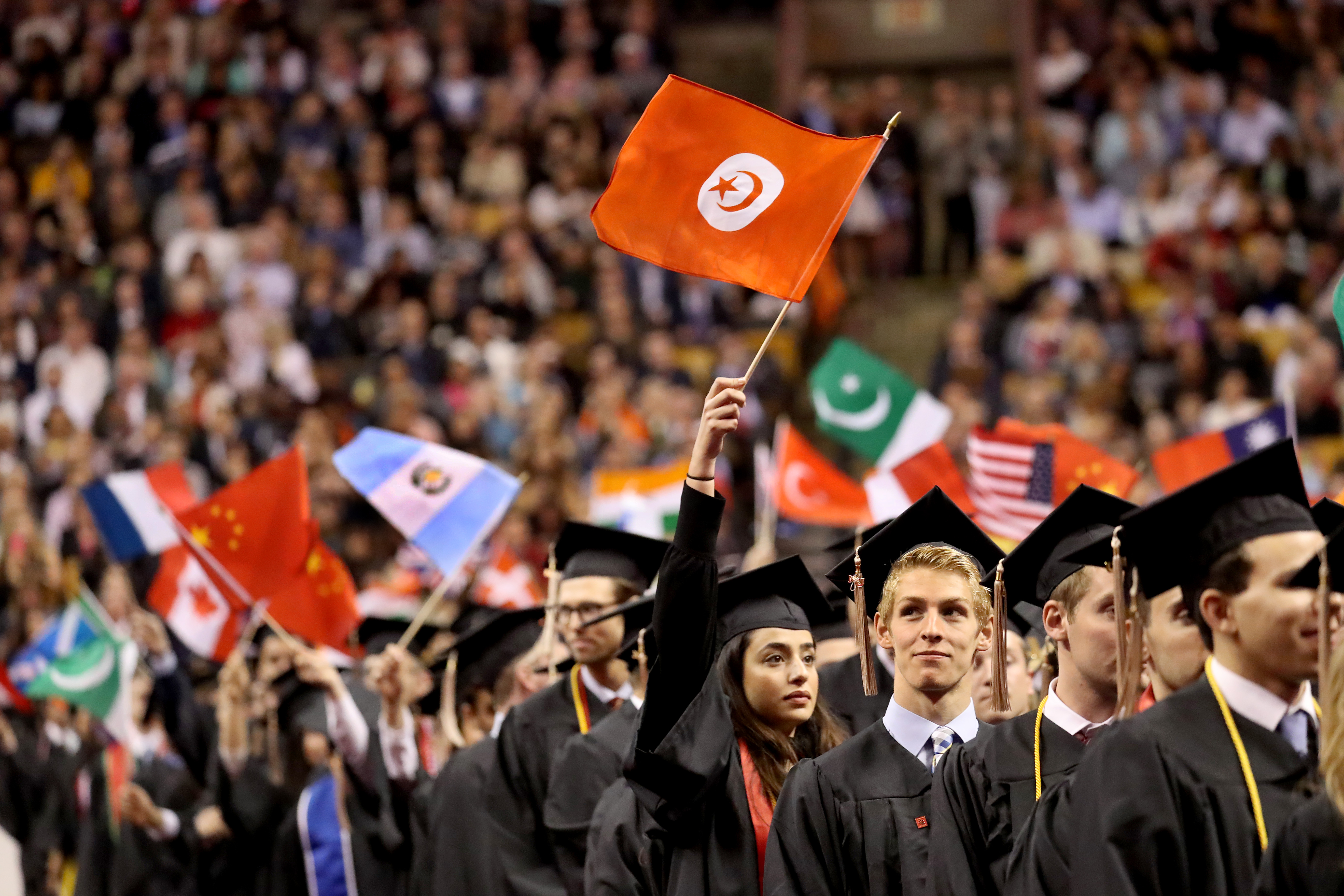 Graduates waved flags signifying their heritage.
