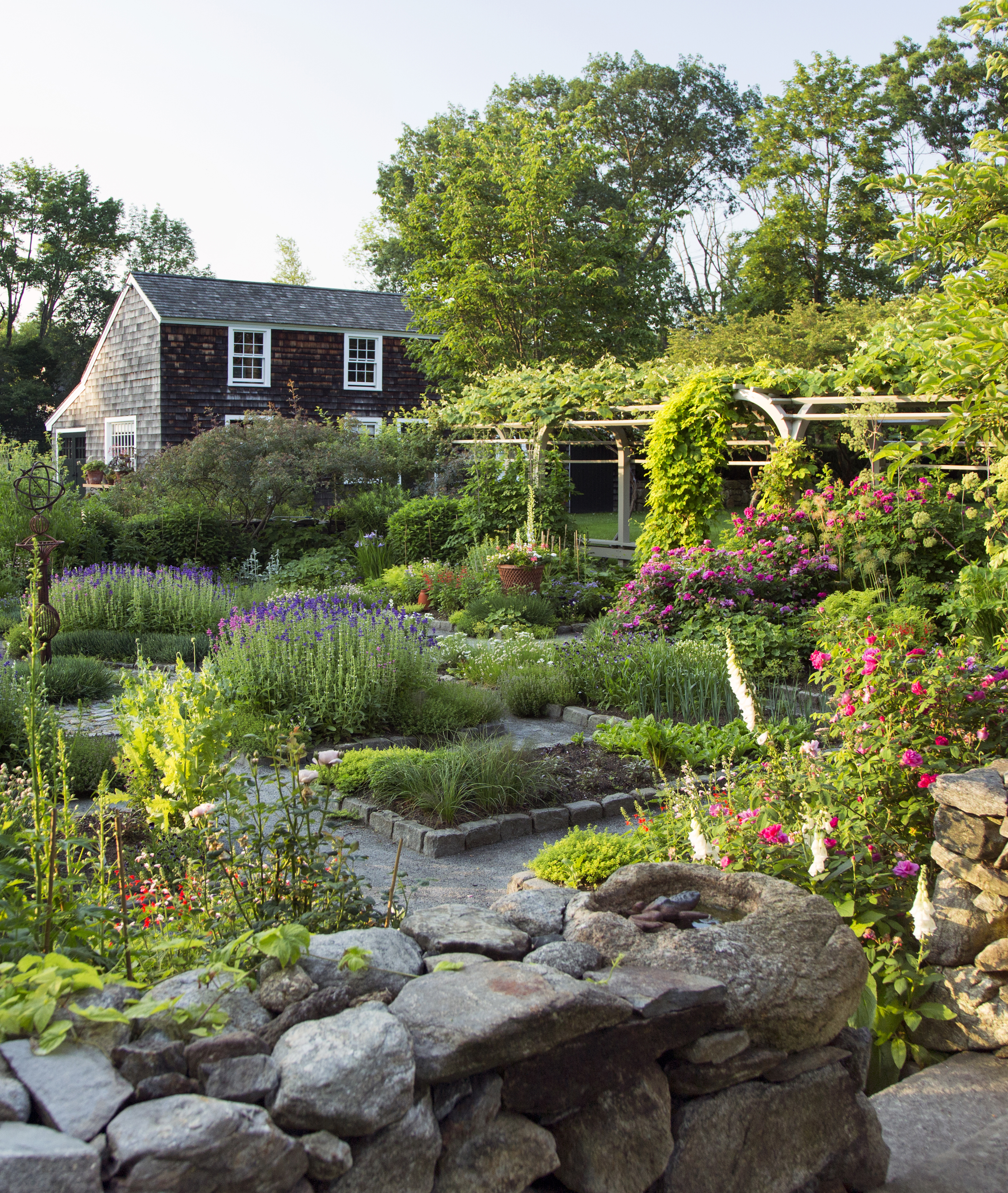 The Walled Garden, with its plots of vegetables and herbs, is the landscape centerpiece of Maureen and Michael Ruettgers’s Carlisle property: Gardens at the Clock Barn.
