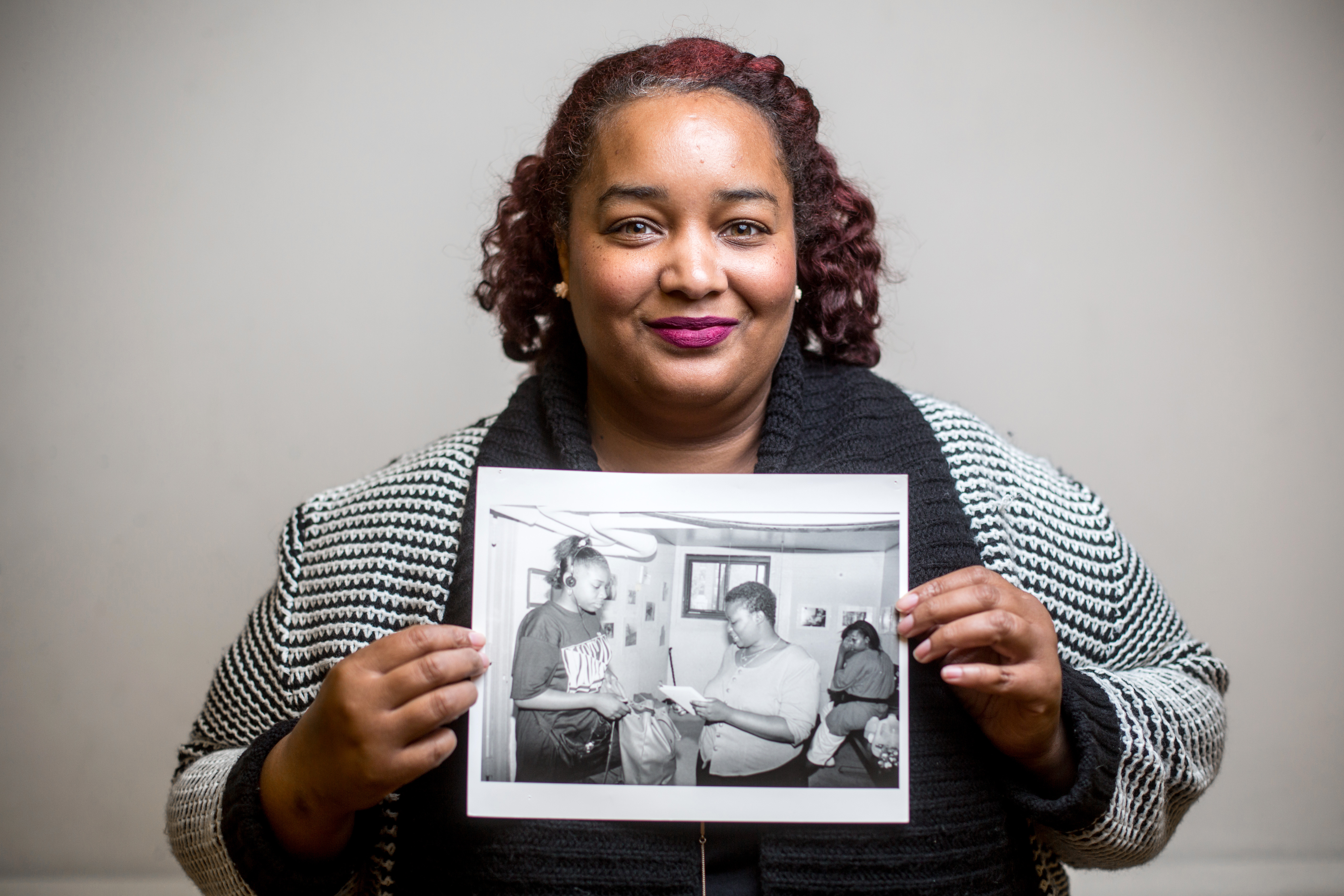 Kenneka Chambers with a photo of herself with friends Cherry Anne Goodridge and Nilda Goodridge.