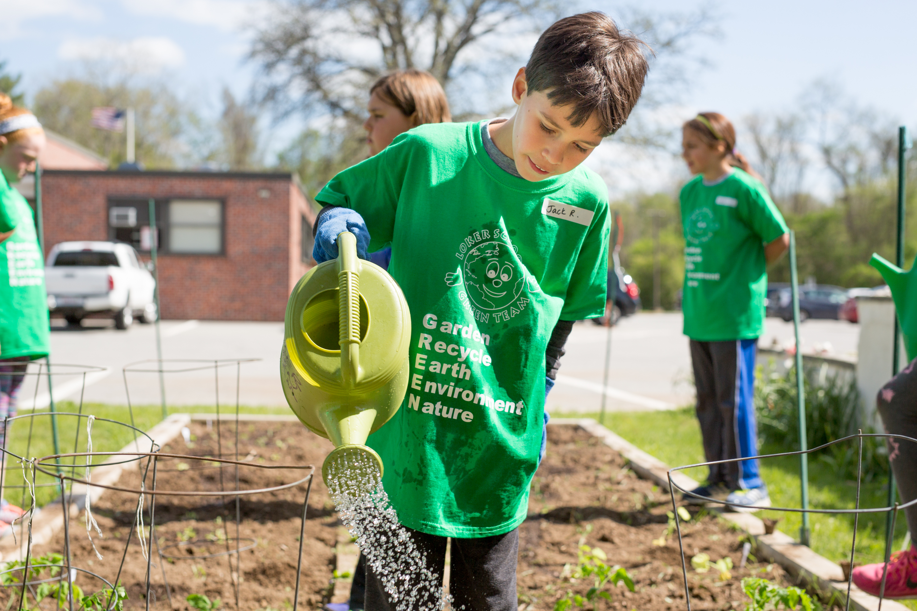 Third-grader Jack Riera waters seedlings at the Loker School in Wayland that will end up on the cafeteria menu.