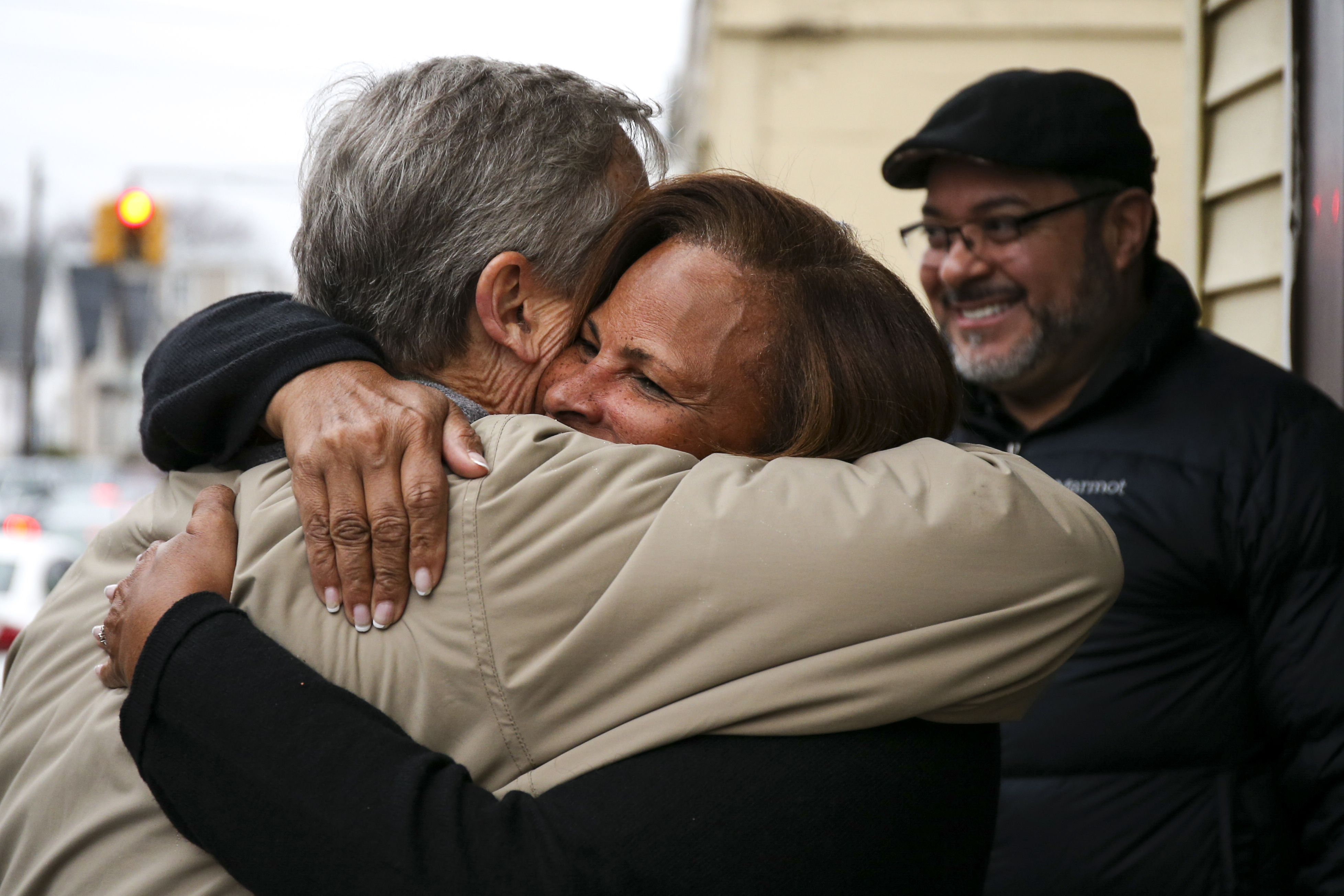 Baker embraced Rosaura Keleher, a school bus driver, outside of Janet Beauty Salon in Lawrence.