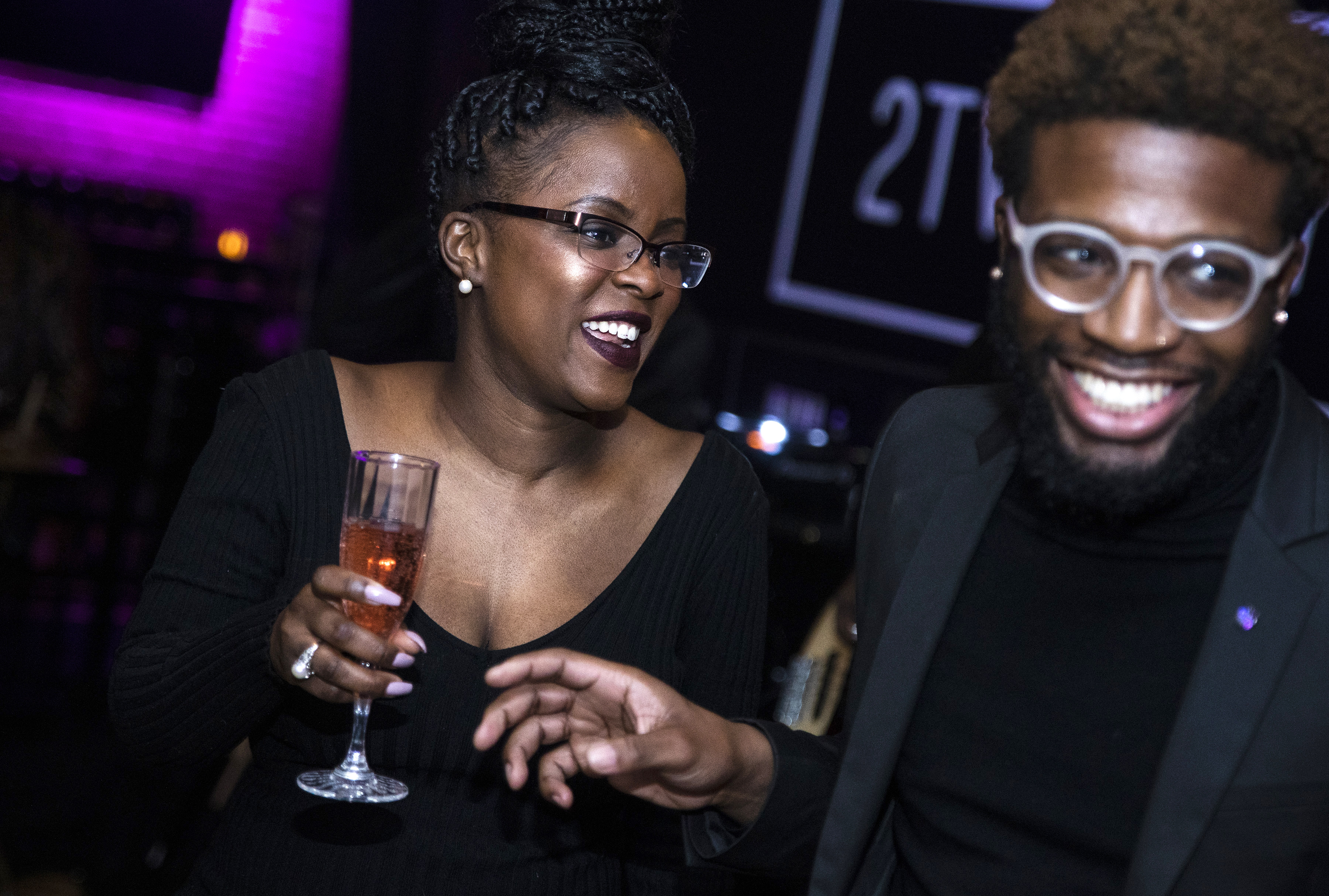 Farrah Belizaire (left) laughs with Devon Austrie at the Toast to Black Excellence event.