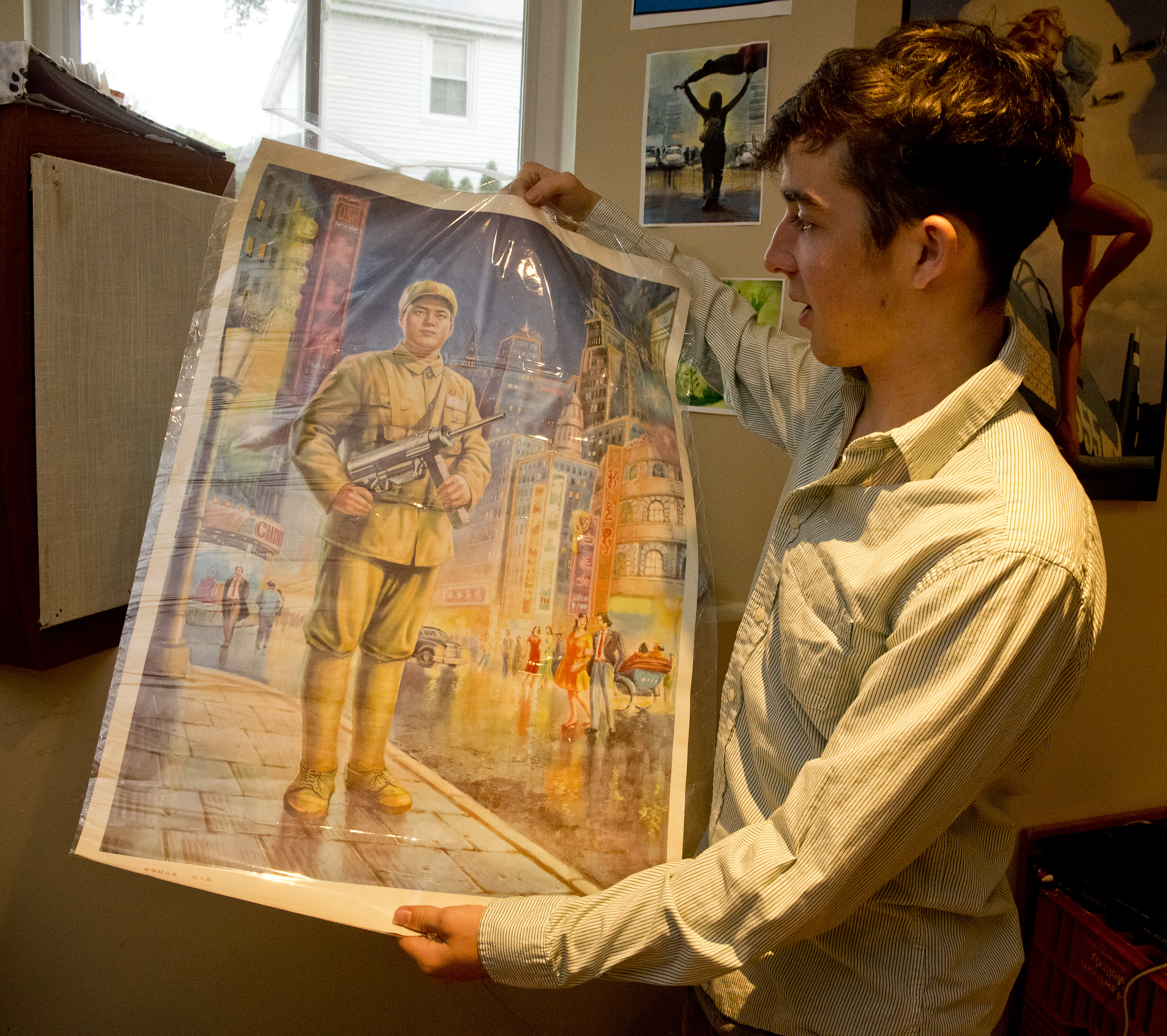 Newton North senior Henry DeGroot held a souvenir poster that he bought on the student trip to China.