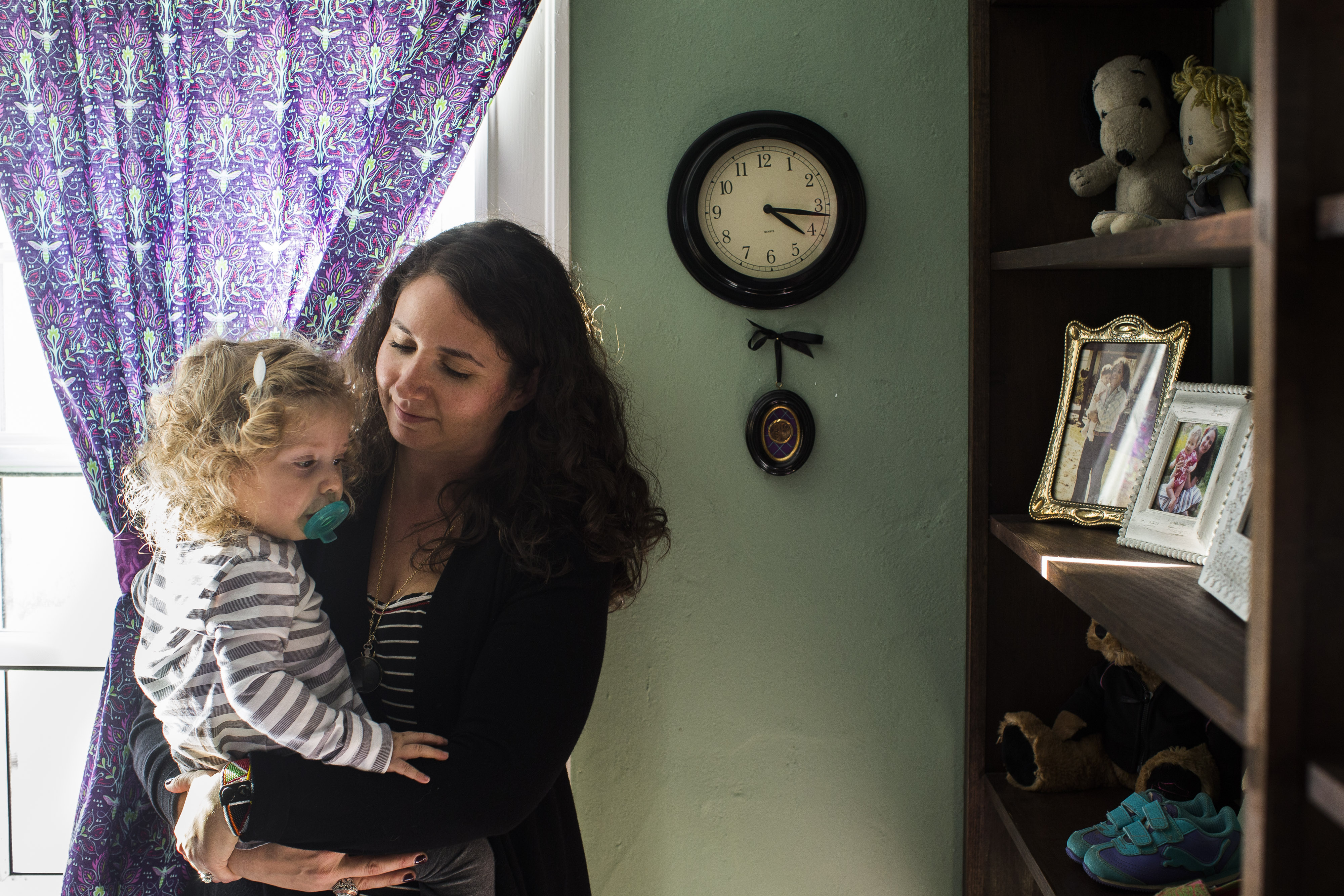 Ashley Buckholtz held her daughter Natasha next to a framed antique broach that once belonged to Buckholtz's great aunt.