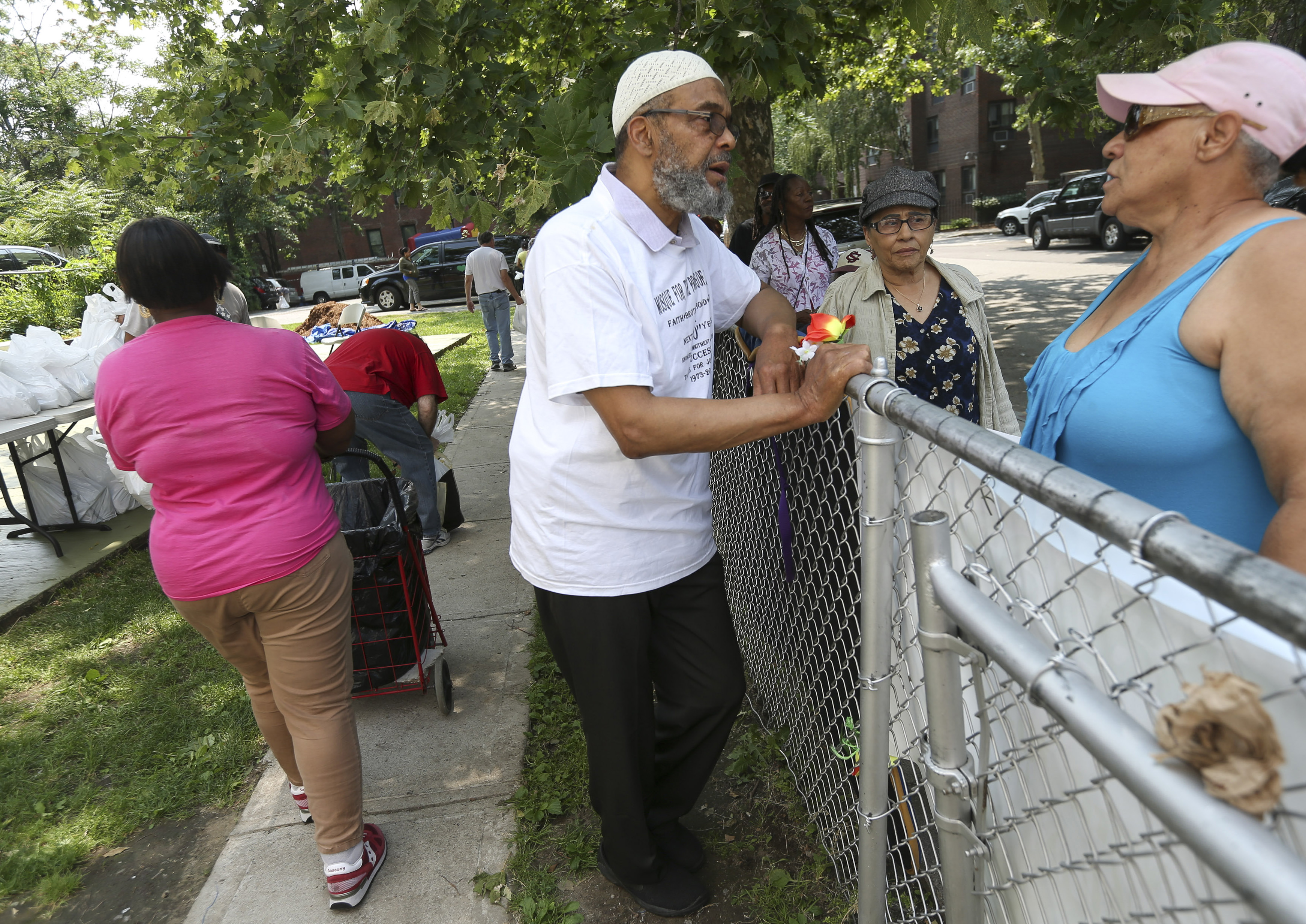 Imam Abdullah Faaruuq greeted residents waiting in line at his Roxbury mosque for the monthly food distribution program.