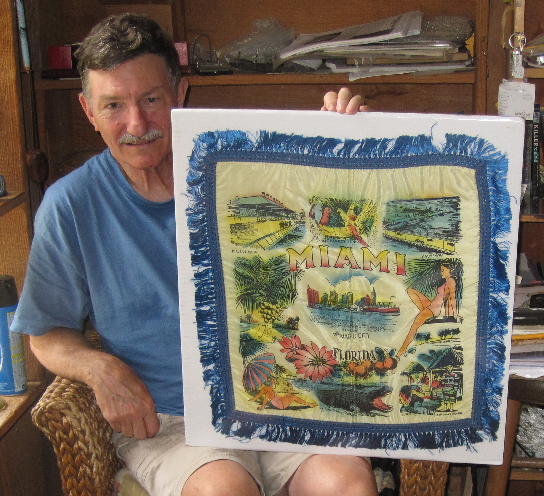 At Roberts Antiques in Micanopy, Fla., Larry Roberts displays a 1950s souvenir Miami pillow sham.