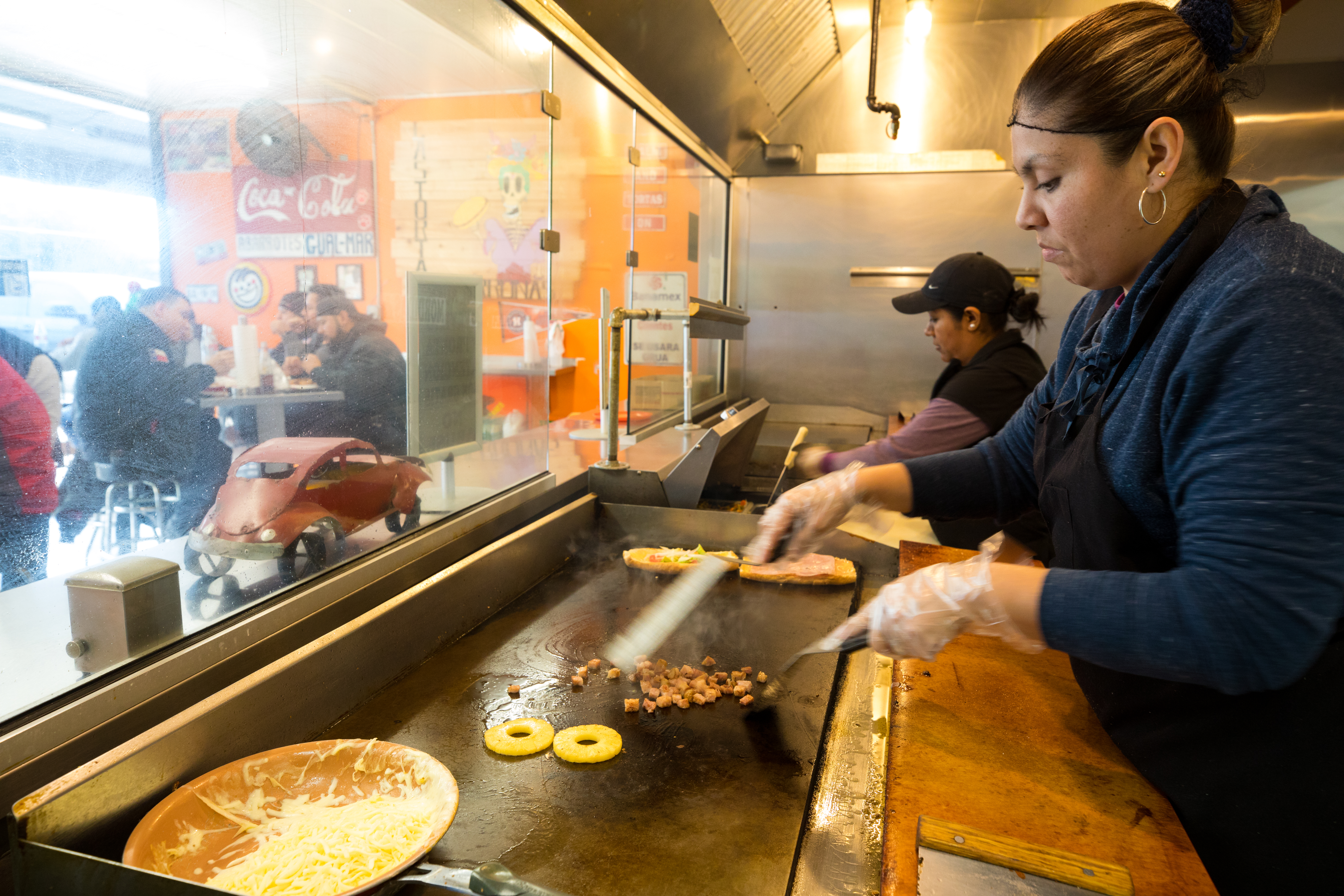 Line cooks preparing tortas at Las Tortas Perronas.