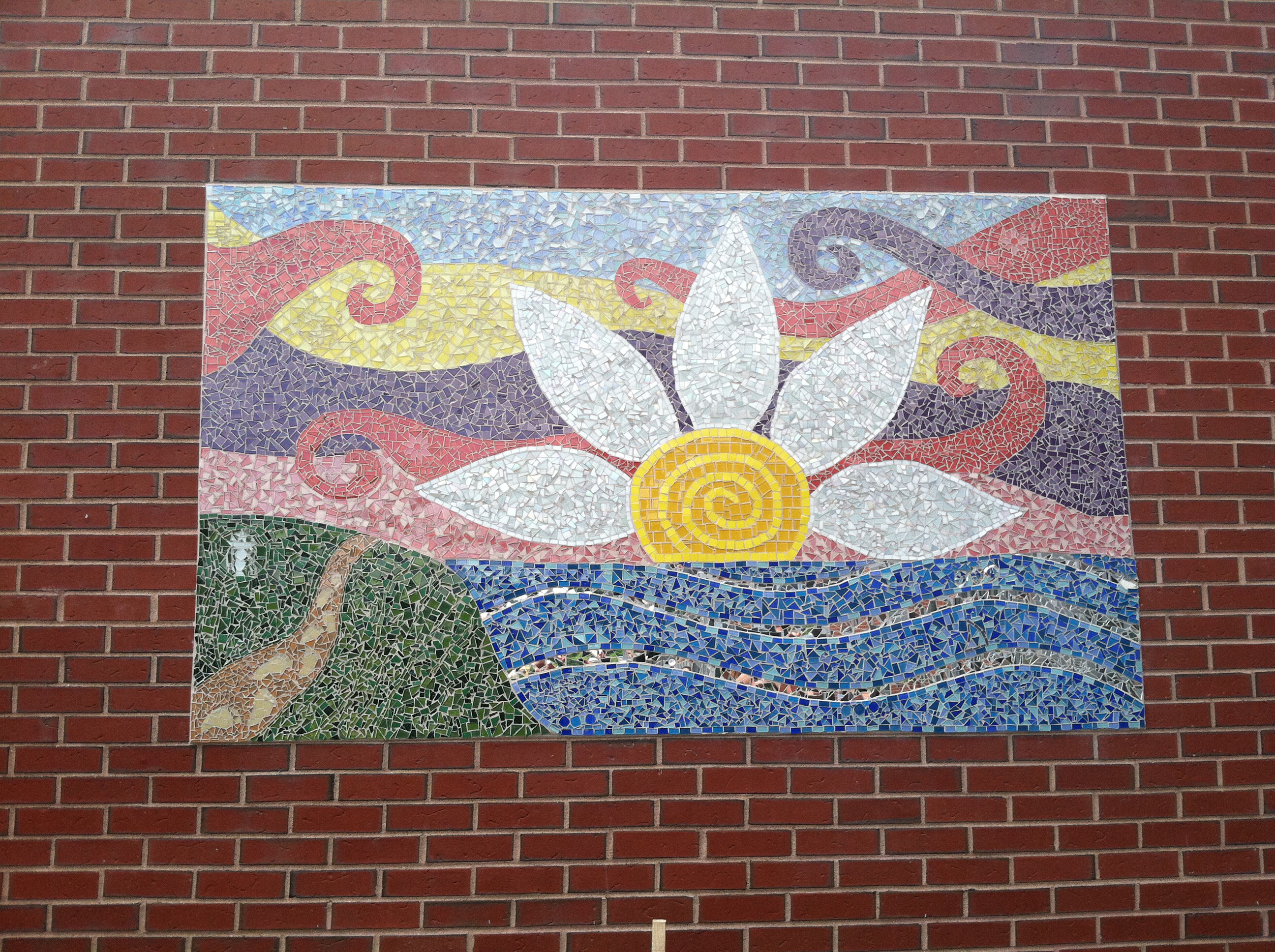 A mosaic at Wayland High School was created in honor of Lauren Astley, with symbols of her life.