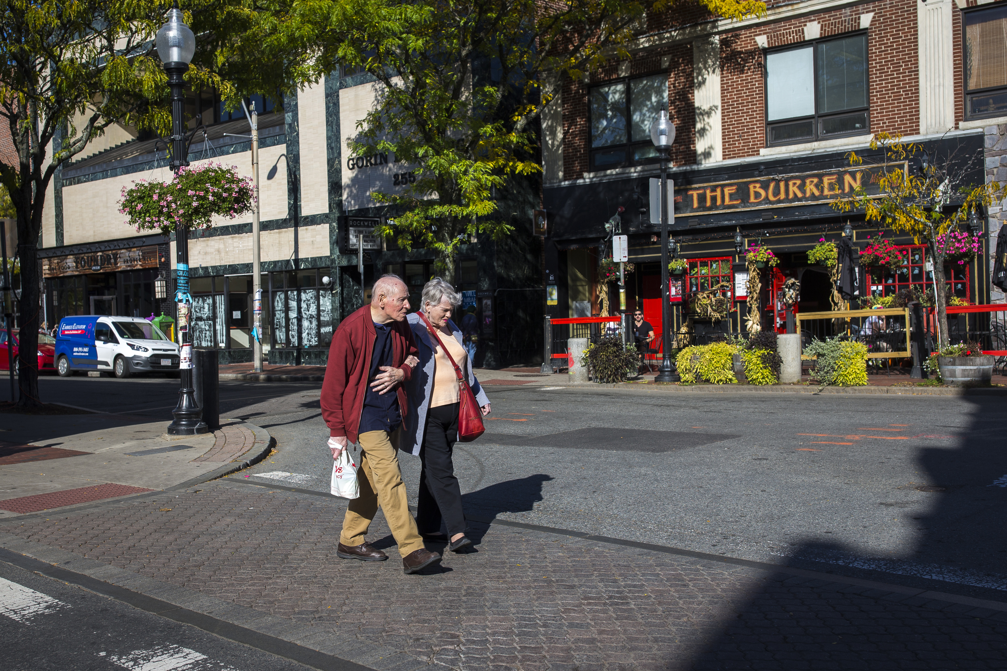 A couple walked along Elm Street in Davis Square.