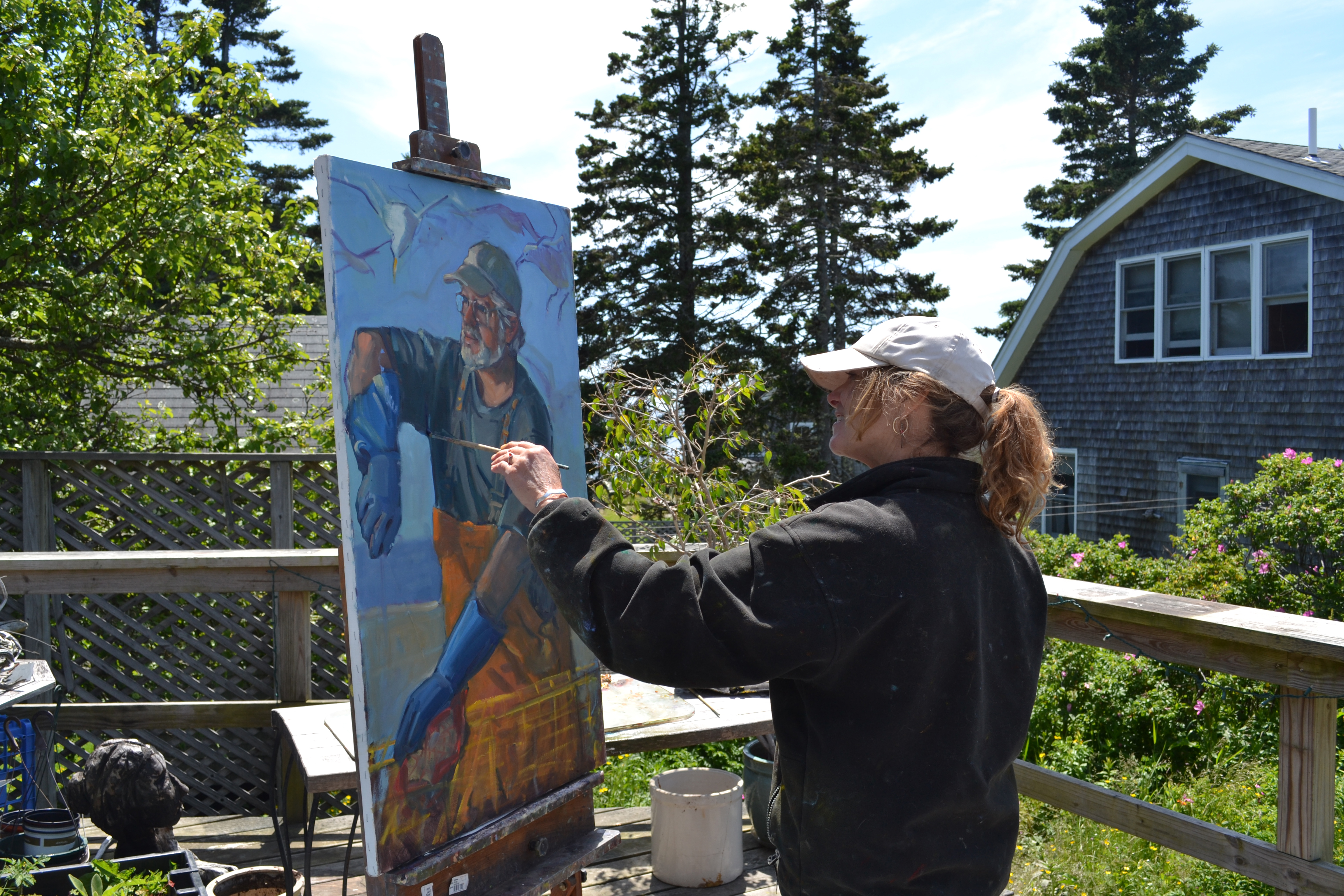 Alison Hill worked on the deck of her gallery and studio.