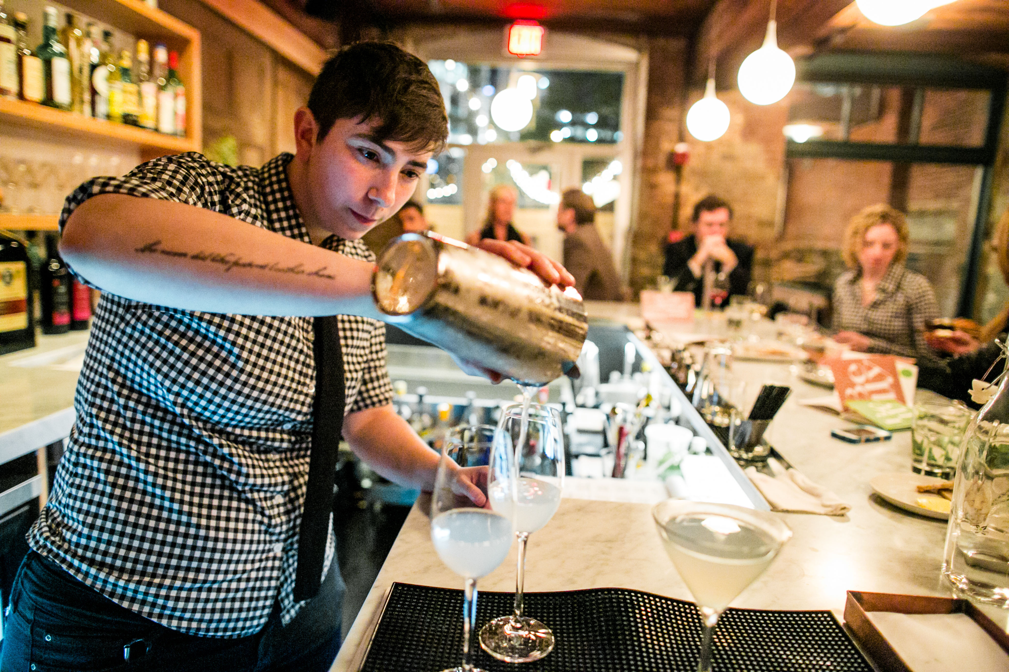 Bar Manager Fanny Katz pours a drink at Belly Wine Bar in Cambridge.