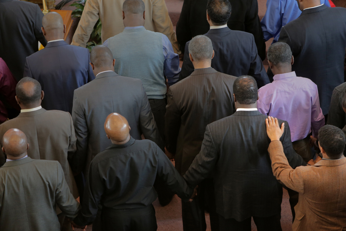 Men attending Sunday’s service at Morning Star Baptist Church in Mattapan approached the front of the church for prayer.