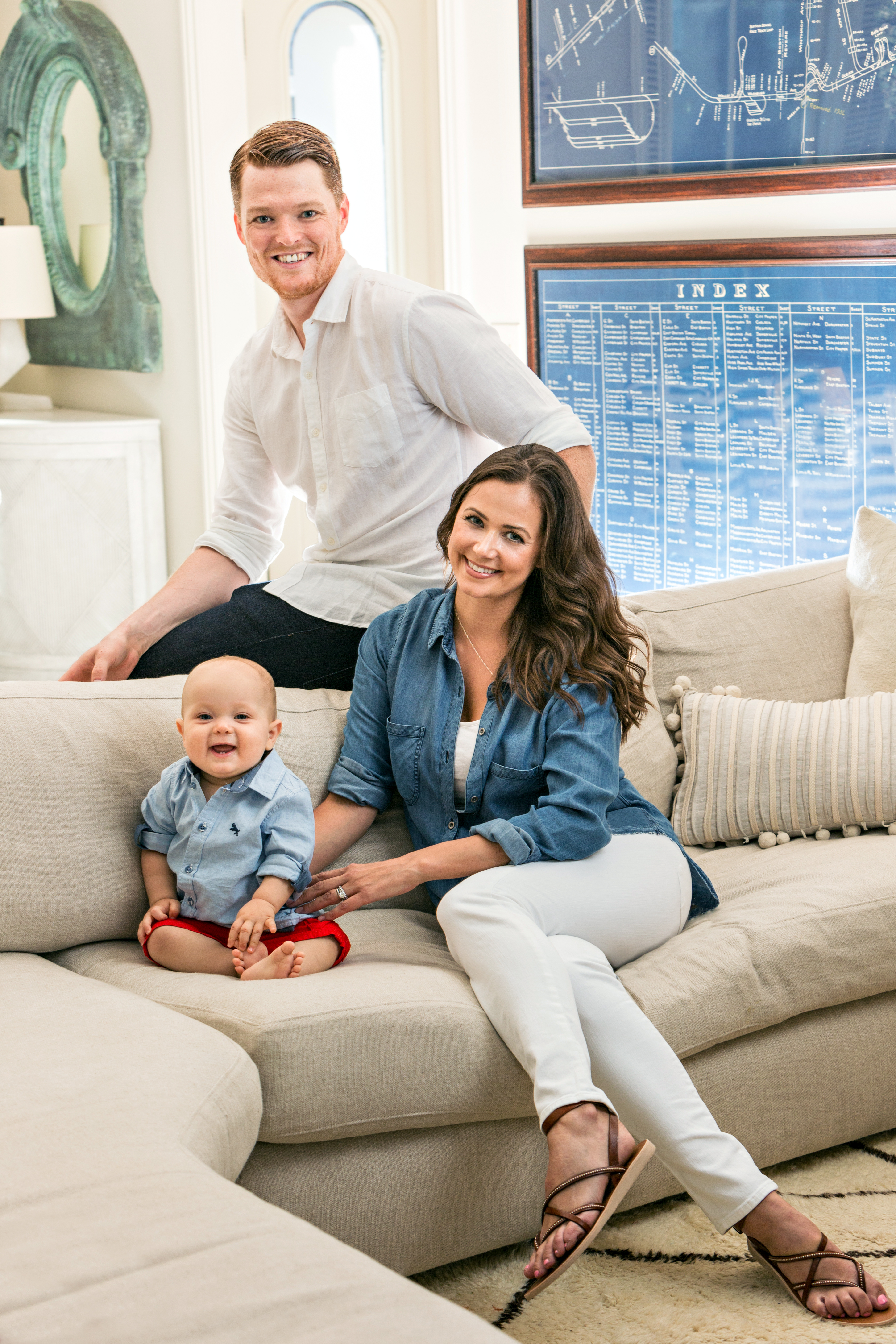In the living area, Jill and Cory Schneider, along with son Wyatt, often relax on the cozy sectional. A pair of oversized rail-track maps nod to Boston’s history.