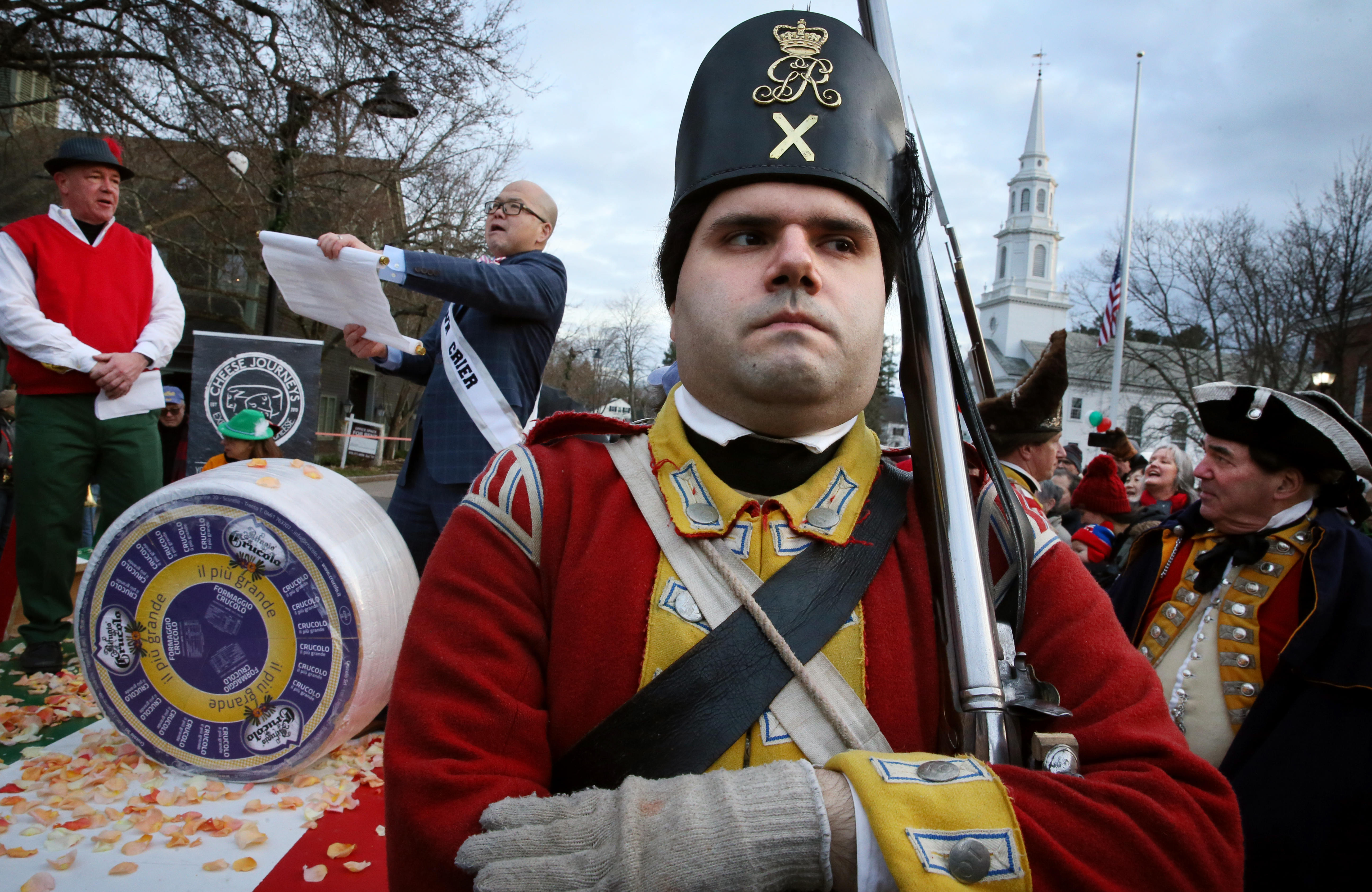 Re-enactor Khalid Antar of His Majesty's Tenth Regiment of Foot kept watch as Lovis and Ng celebrated the cheese wheel’s arrival.