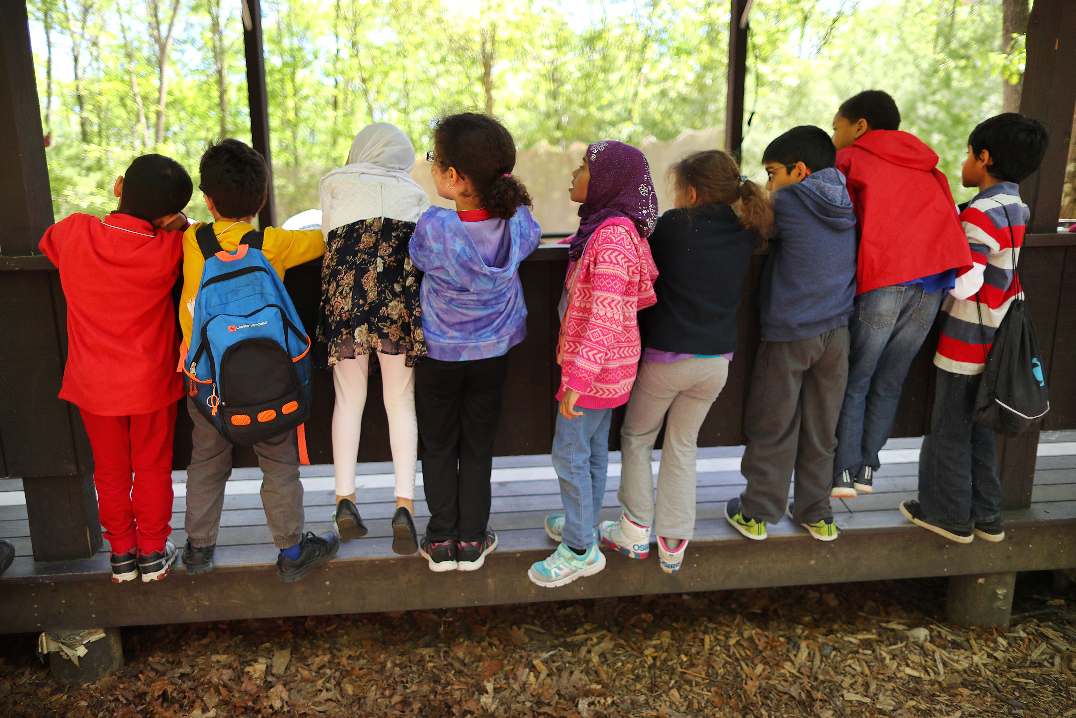 Youngsters from the Islamic Academy for Peace in Methuen stood at a railing to watch a lesson in archery at the Scouts’ New England Base Camp facility in Milton.