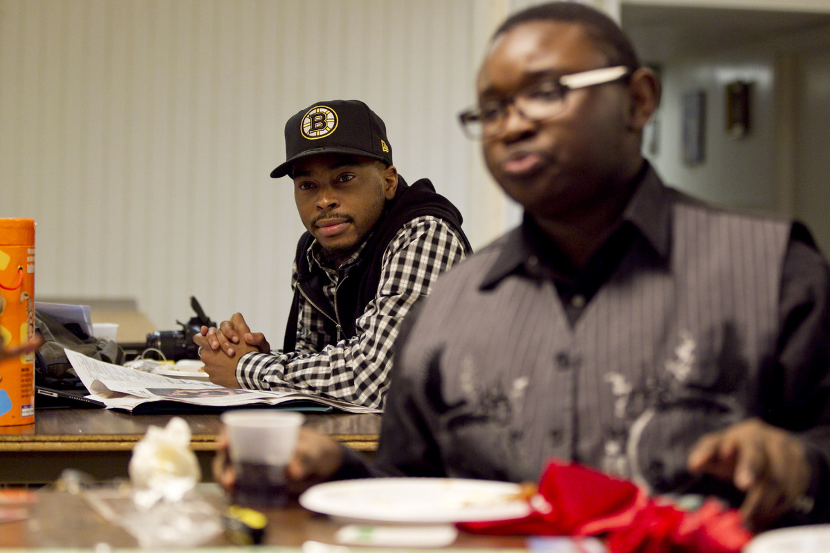 Quincey Roberts (rear), a case manager for the Youth Lounge, watched as a group that included Eziah Karter-Sabir Blake played Monopoly in the basement of Union United Methodist Church in the South End. The Youth Space, a drop-in program that welcomes participants of all sexual orientations, is housed in the basement of the historically black church.