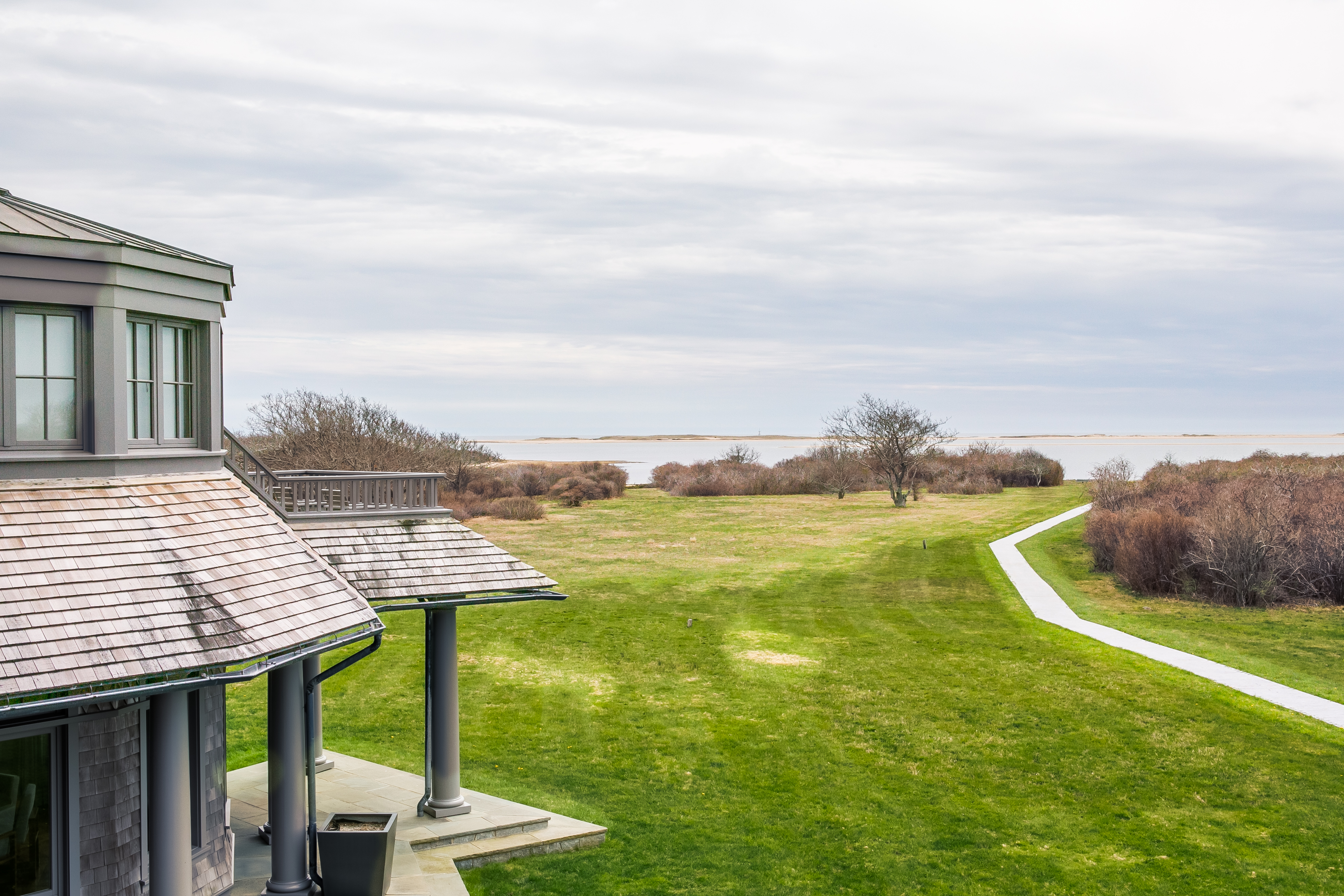 A path leads from the house down to the water.