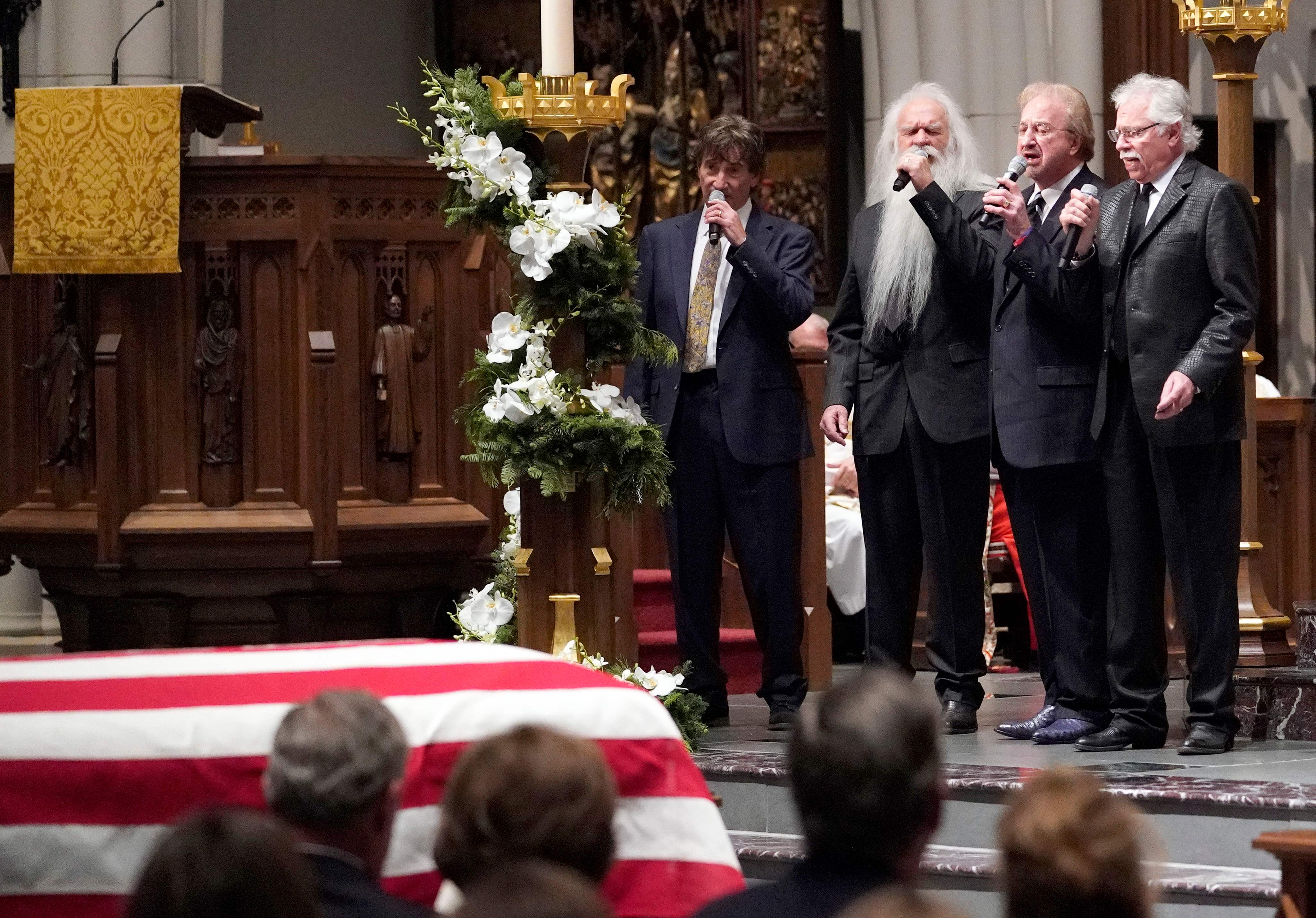 The Oak Ridge boys sing "Amazing Grace" during a funeral service.