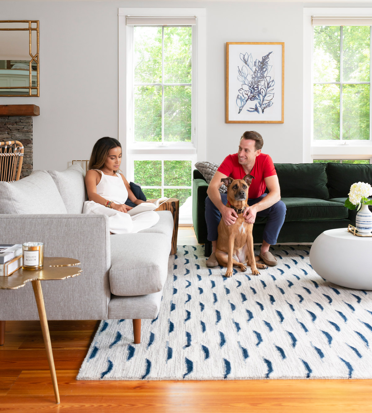 Desiree and Christian Burns and their Lab-mix rescue dog, Sloane, in the living room of their Newport getaway, which they purchased in the spring of 2017.