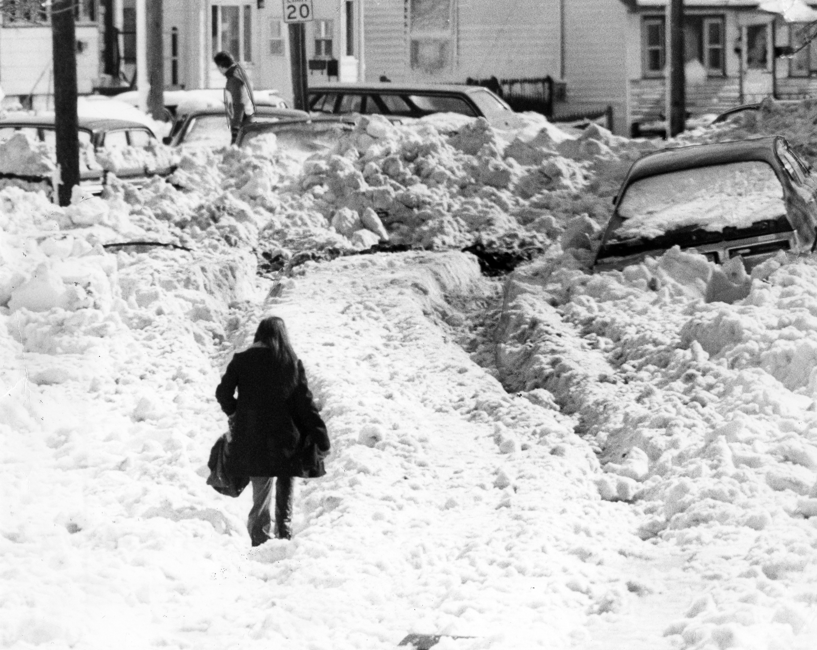 A woman walked through the snow and water on Dolphin Avenue in Revere after the blizzard.