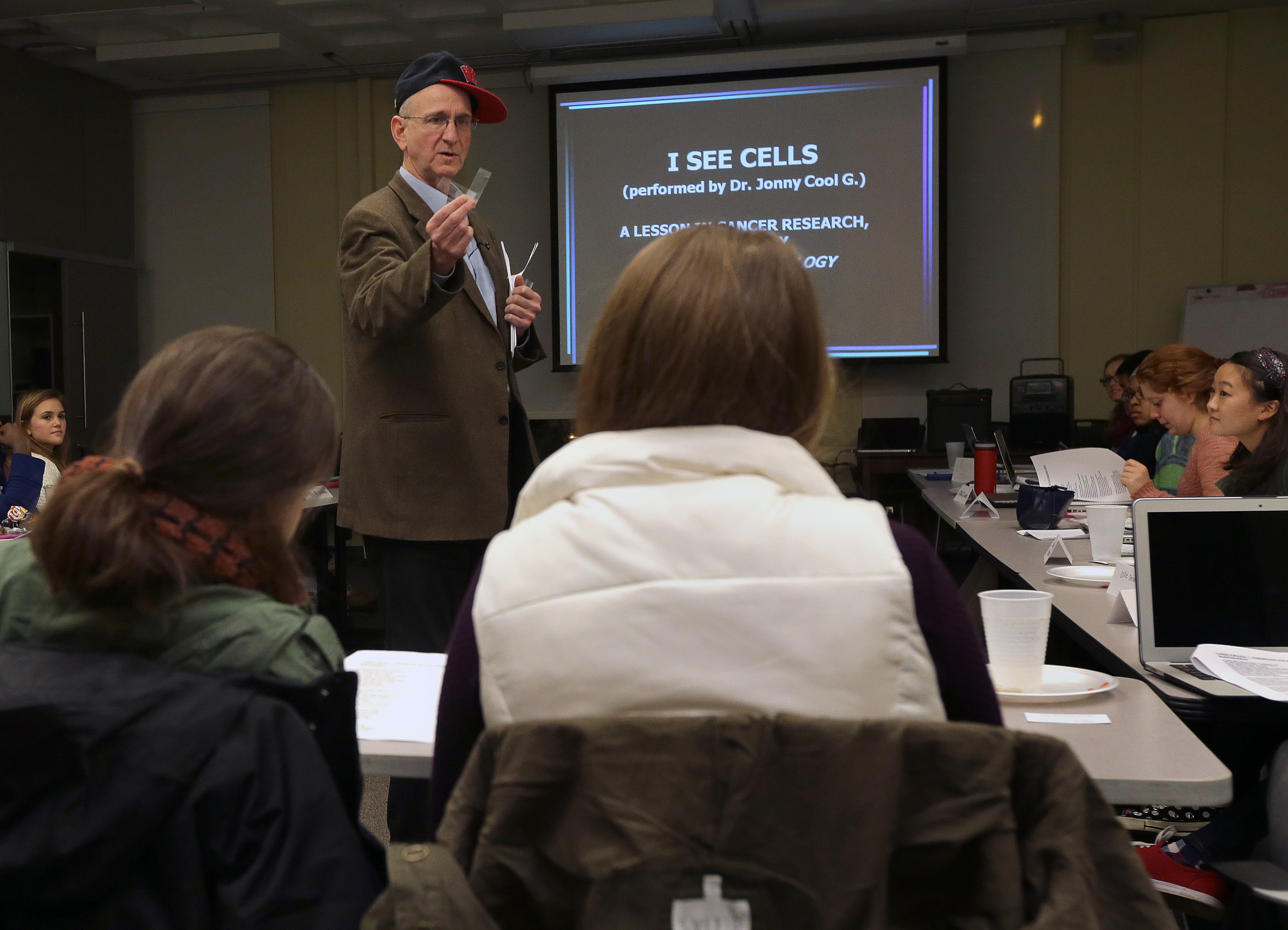 With his hat propped to one side, Professor Jonathan Garlick rapped about stem cells during a class at Tufts University.