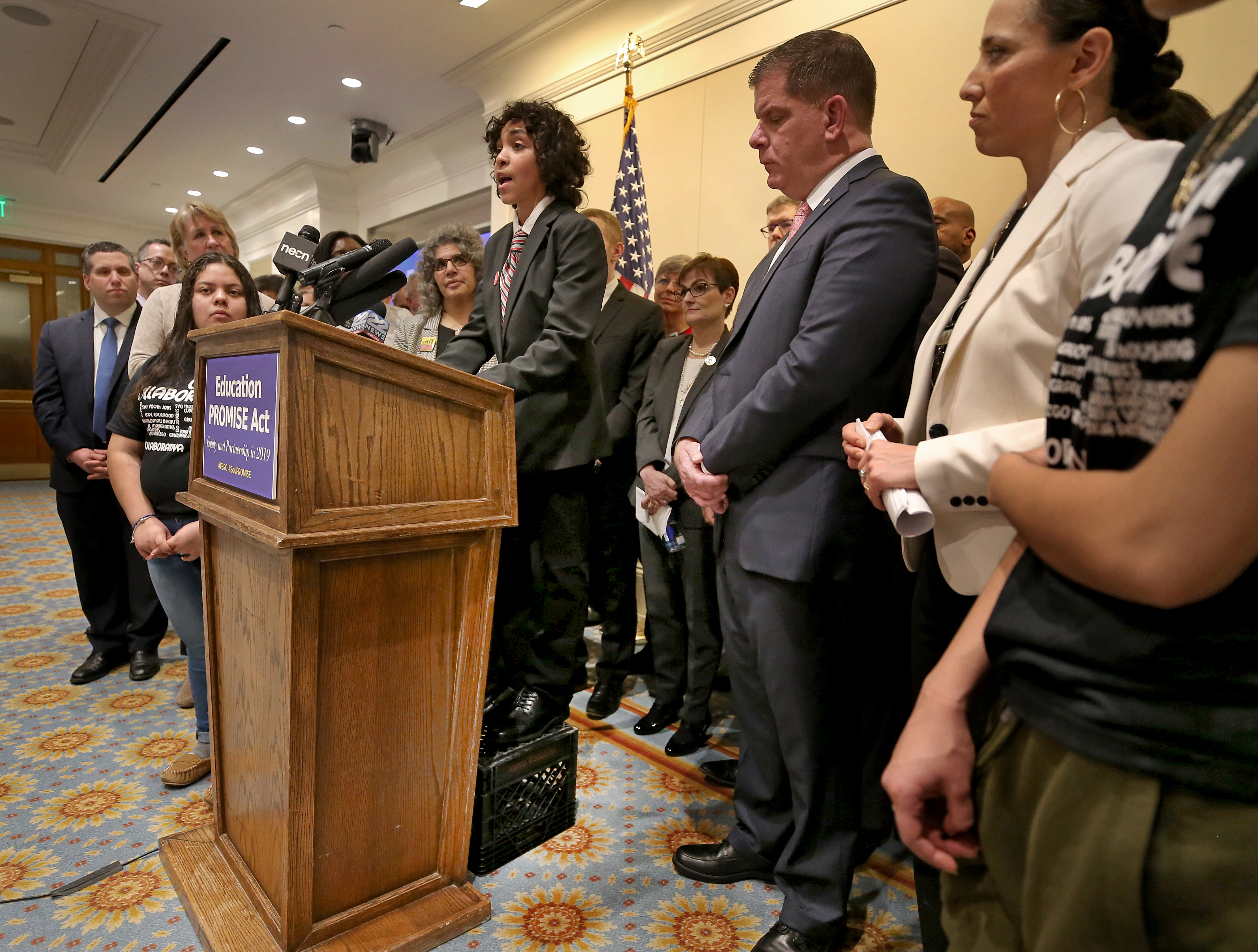 Jose Cruz, a 13 year-old student enrolled in Chelsea Brown Middle School, spoke at the podium with the aide of a milk crate.