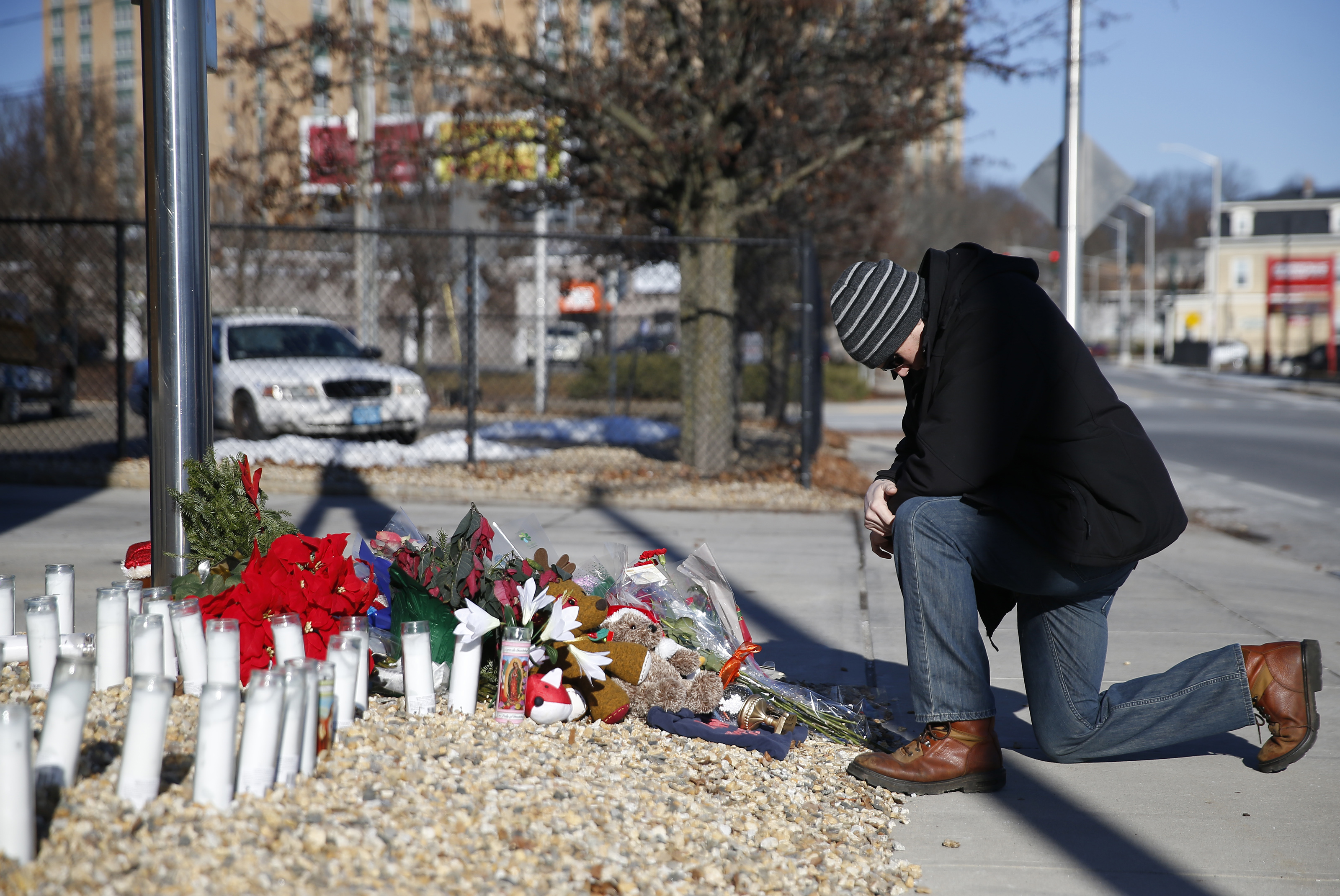 Worcester, MA, 12/10/2018 -- Justin Collard of Worcester knelt to pray at a makeshift memorial in tribute to fallen firefighter Christopher J. Roy outside of his fire station. (Jessica Rinaldi/Globe Staff) Topic: 11worcesterpic Reporter: