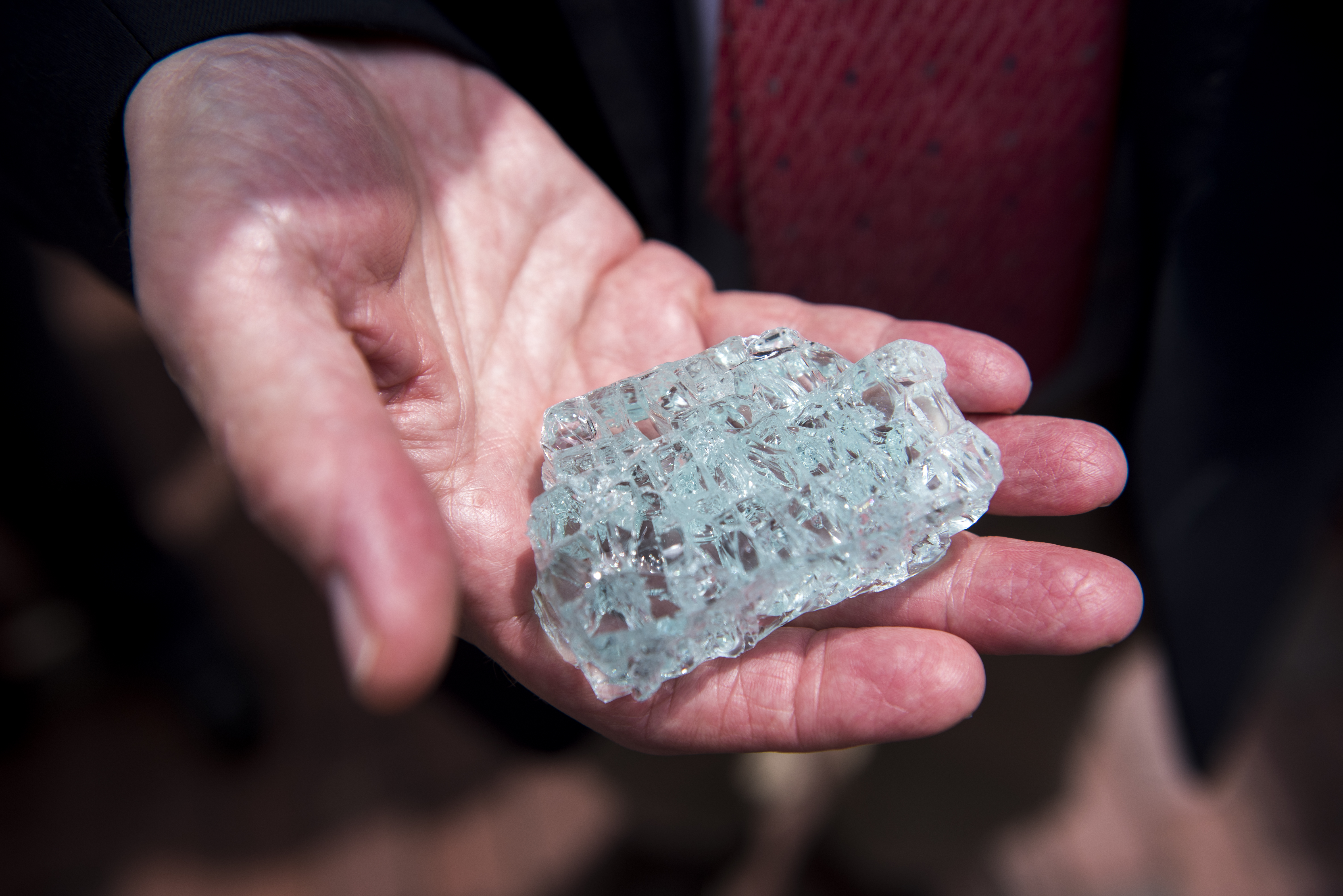 Barry Shrage held a piece of the broken memorial after the rededication ceremony of the New England Holocaust Memorial.