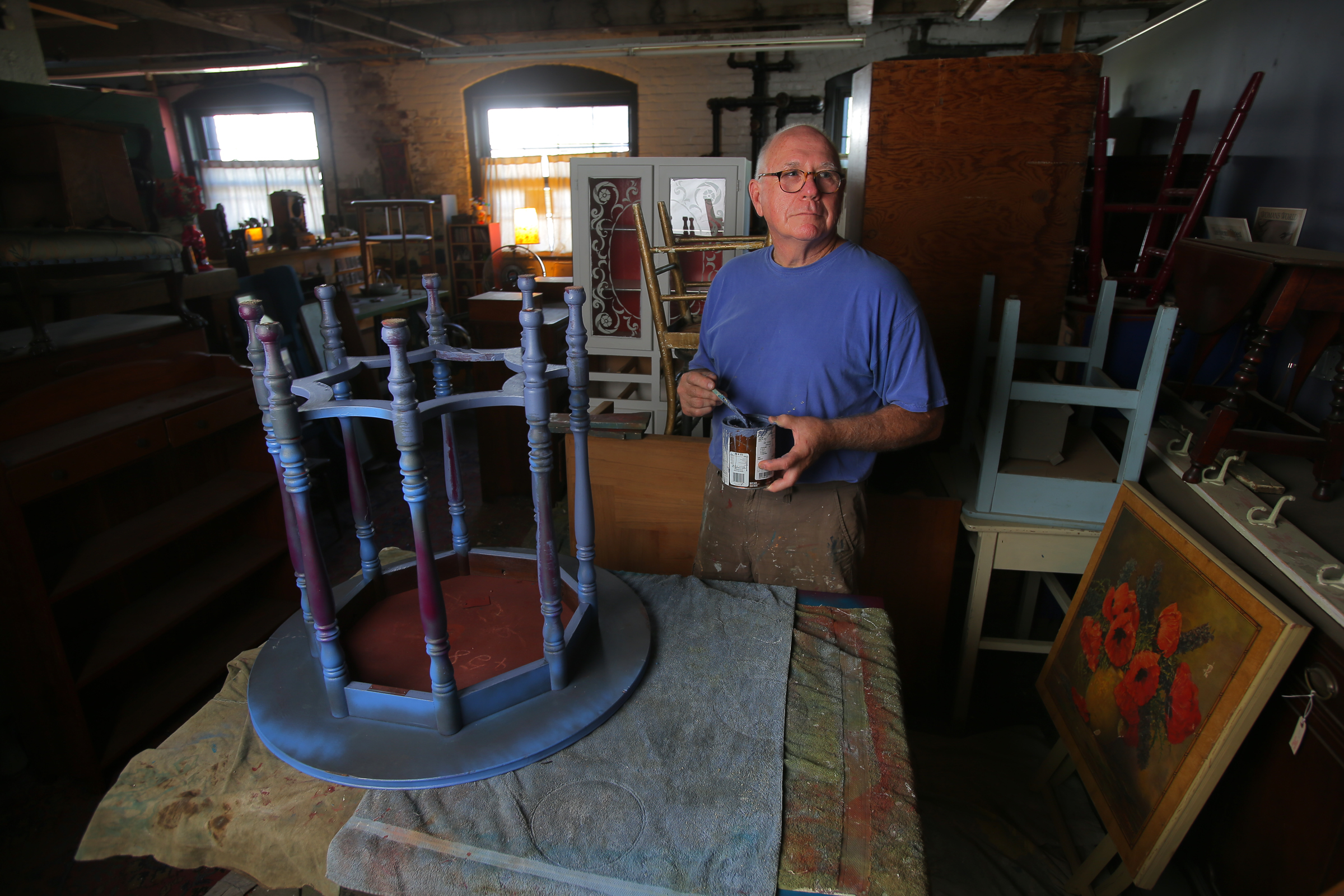 Jim McIntyre, the team’s first head coach, in his furniture restoring studio.