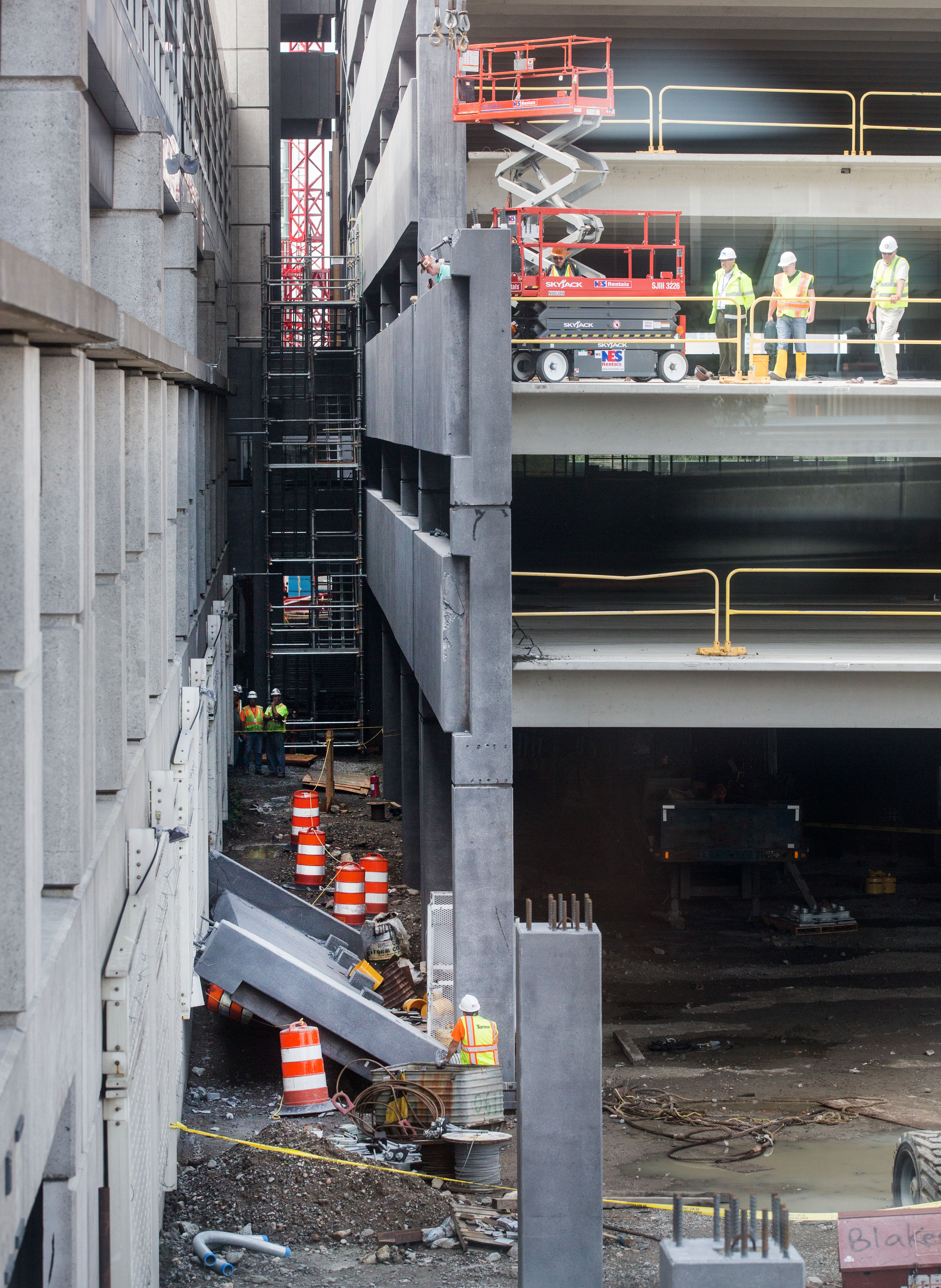 Workers looked at a large slab of concrete that could be seen wedged between the Central Garage and an extension being built at Logan.