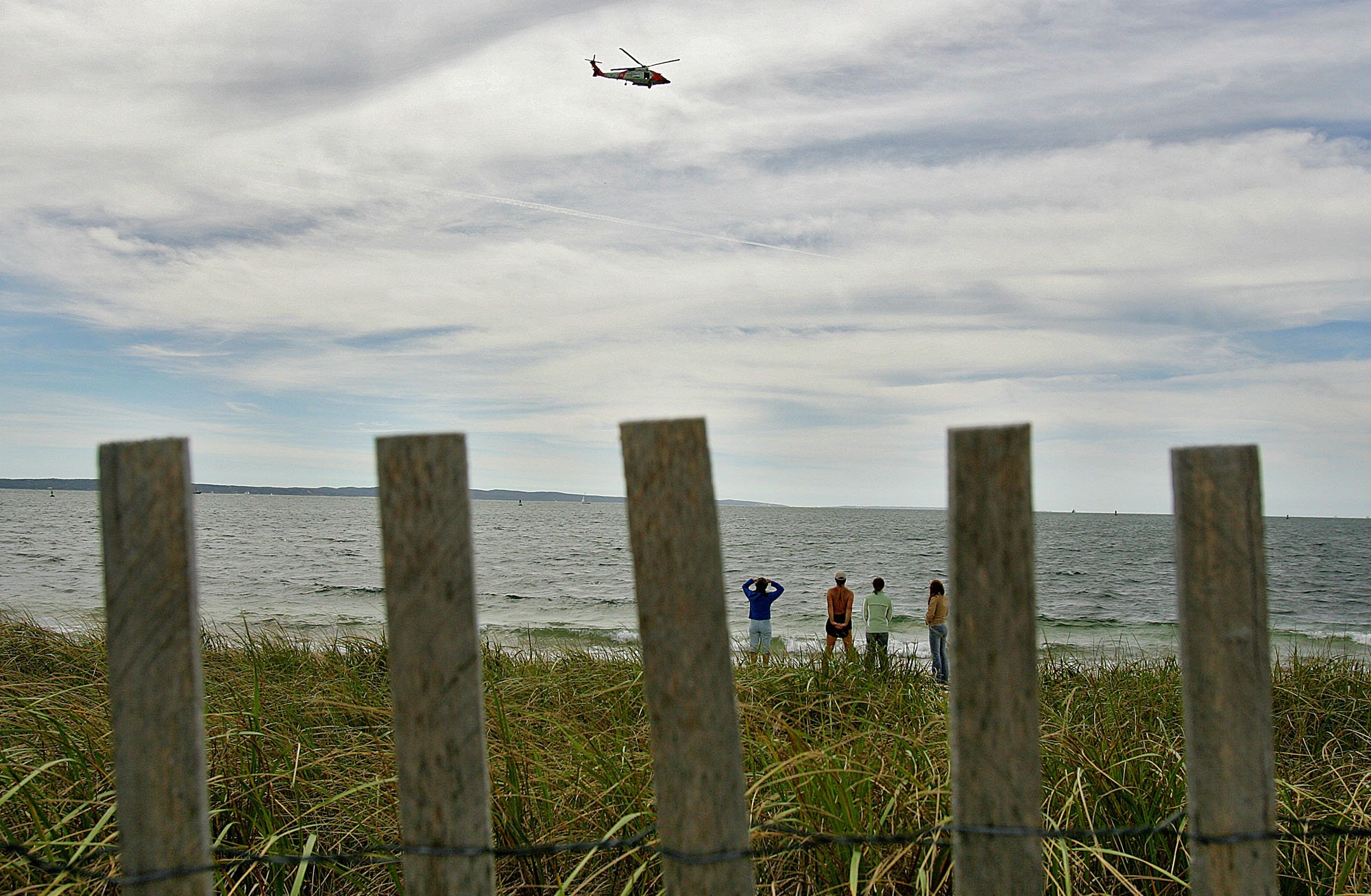Beachgoers stood along the beach in Falmouth.
