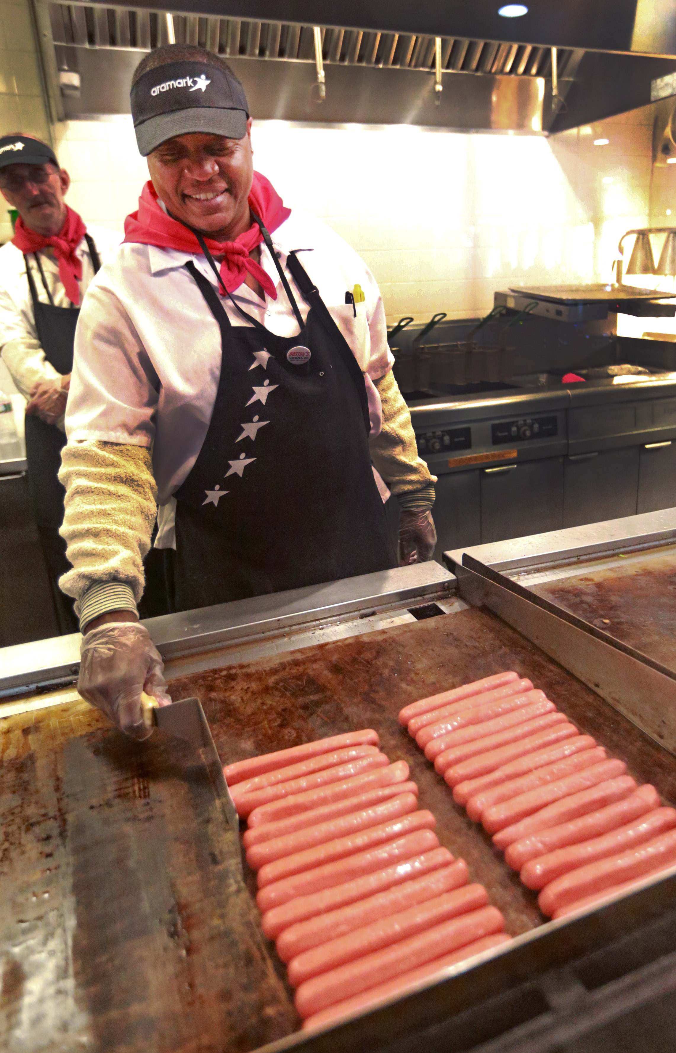 Bobby Oliver cooked hot dogs at a concession stand at Fenway Park on Tuesday.