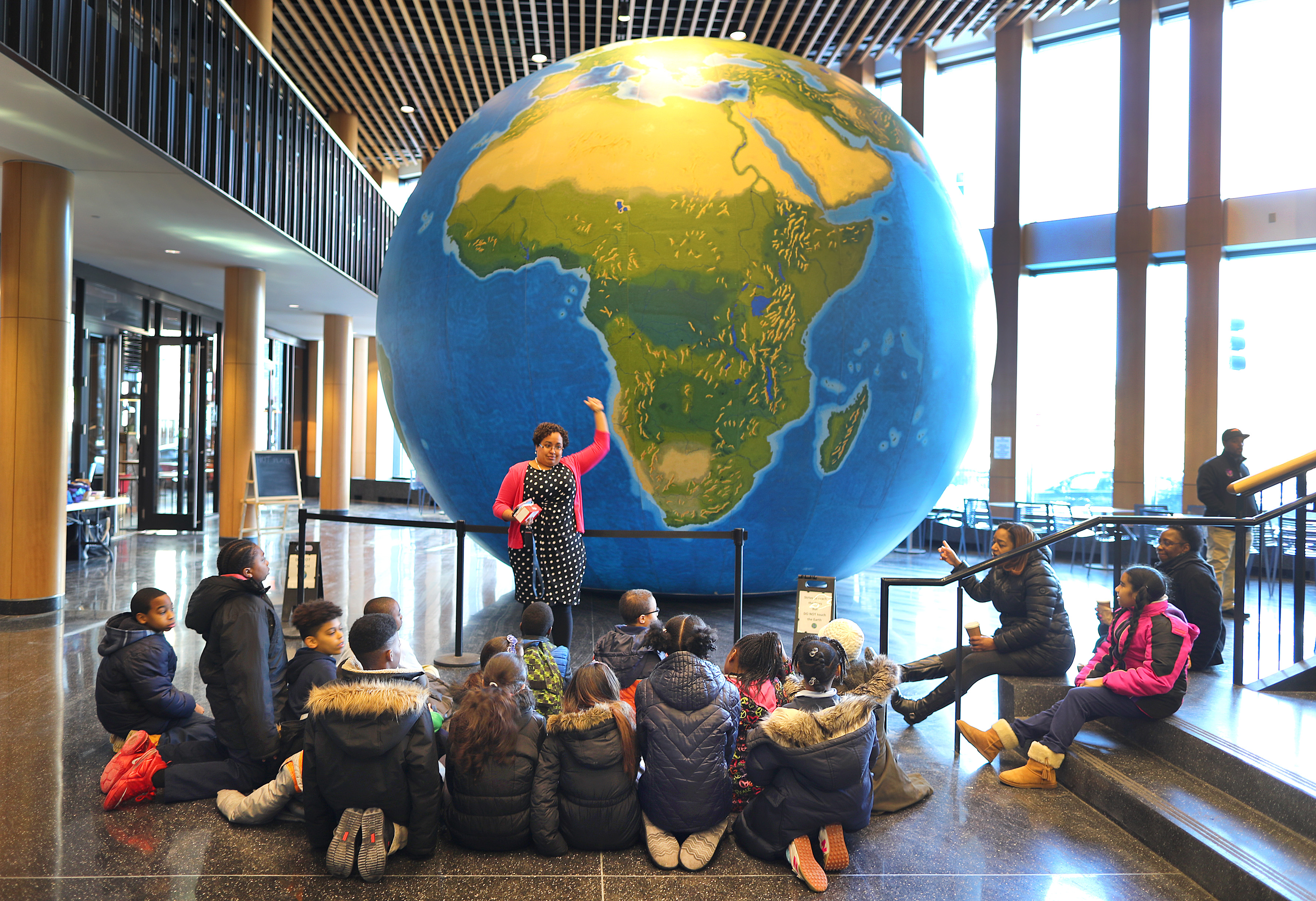 Natacha Scott used this inflatable globe on display at Boston Public School headquarters on Thursday to explain the size of countries to students from The Nathan Hale School.