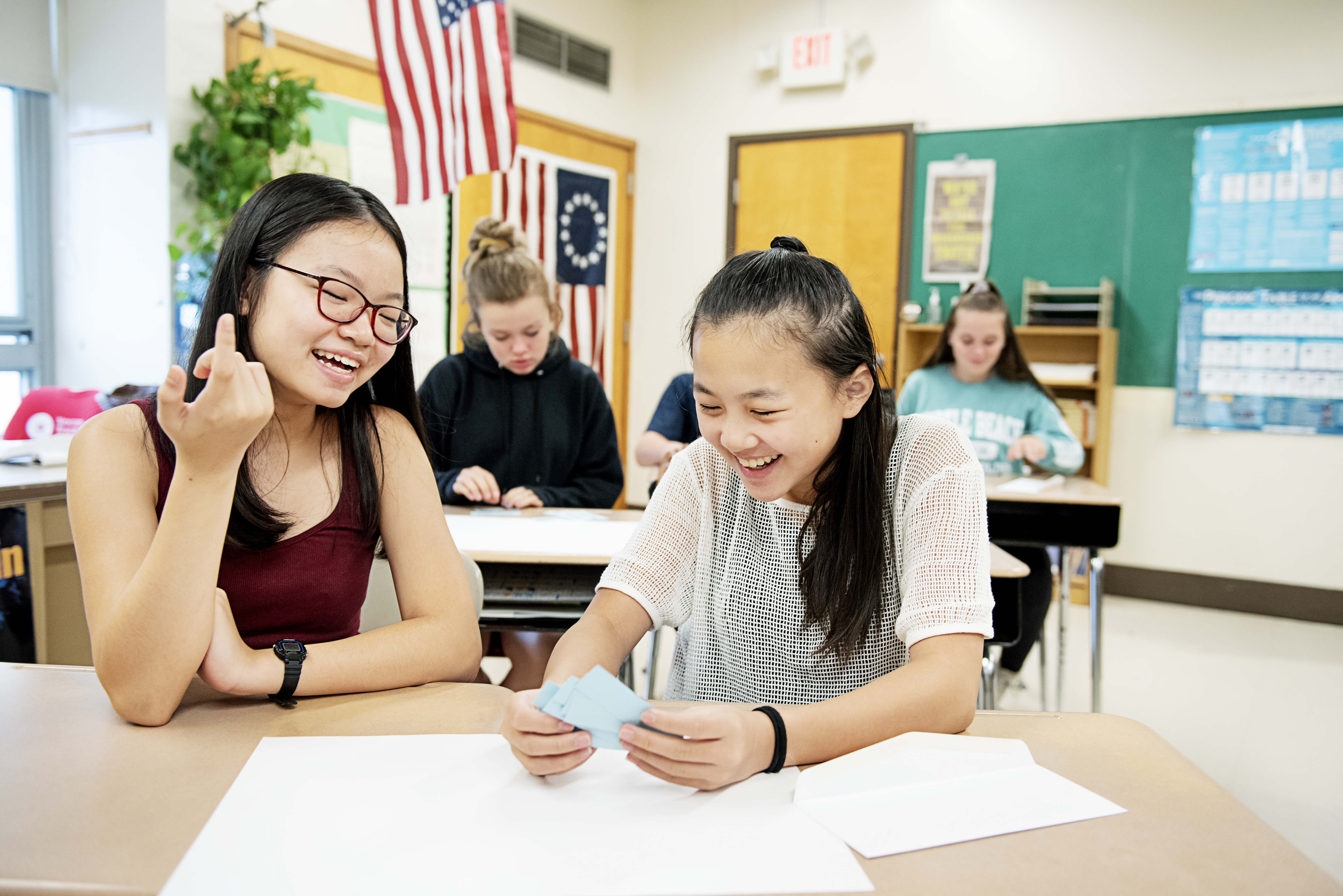 Linh Dieu (left) and Melody Chuong in civics class at Newton’s Bigelow Middle School.