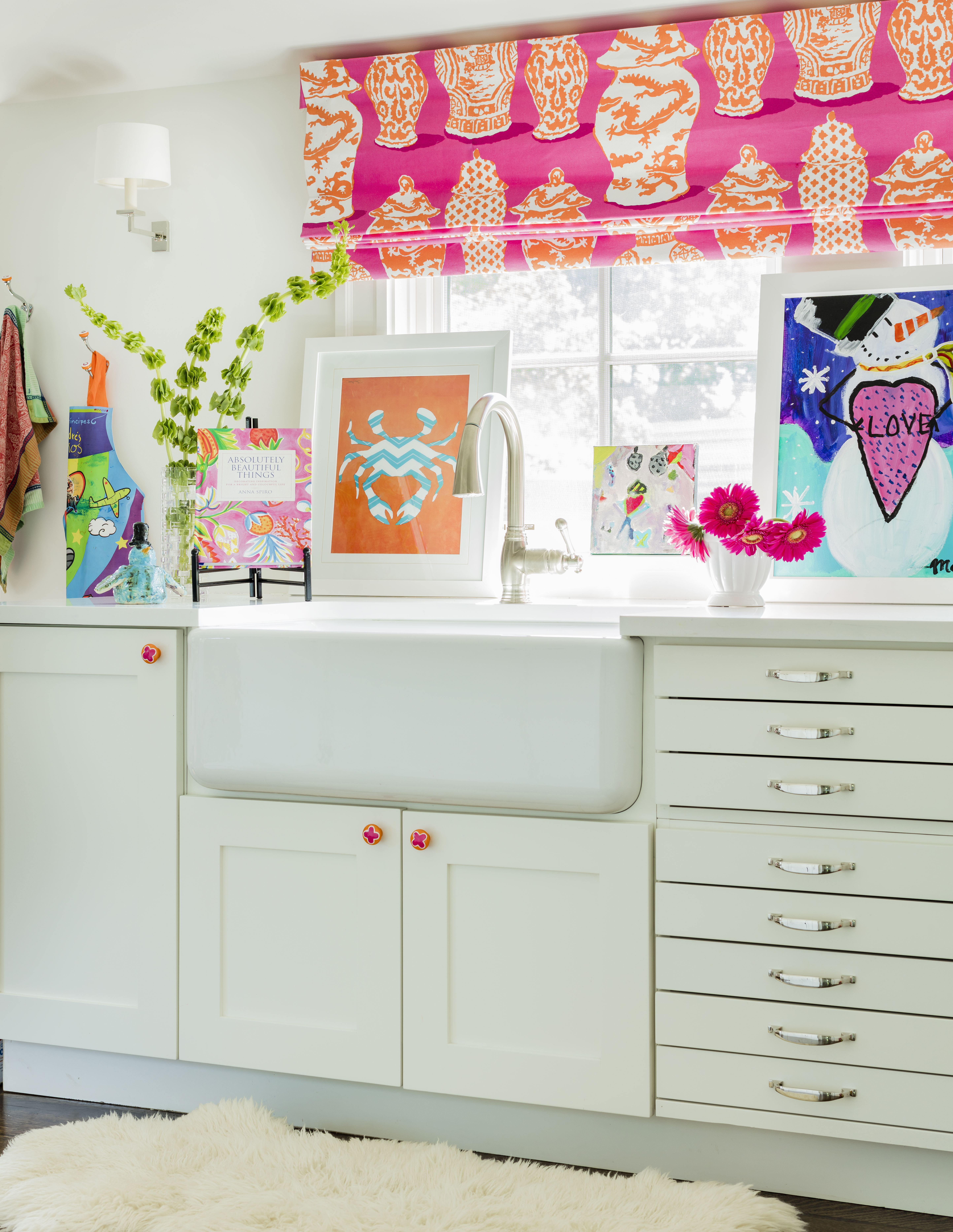 The kitchen’s white cabinetry and gray marble counters and backsplash keep things bright but not too monochromatic. Fixtures, says Ward, “have a handcrafted, warm, textural appeal.”