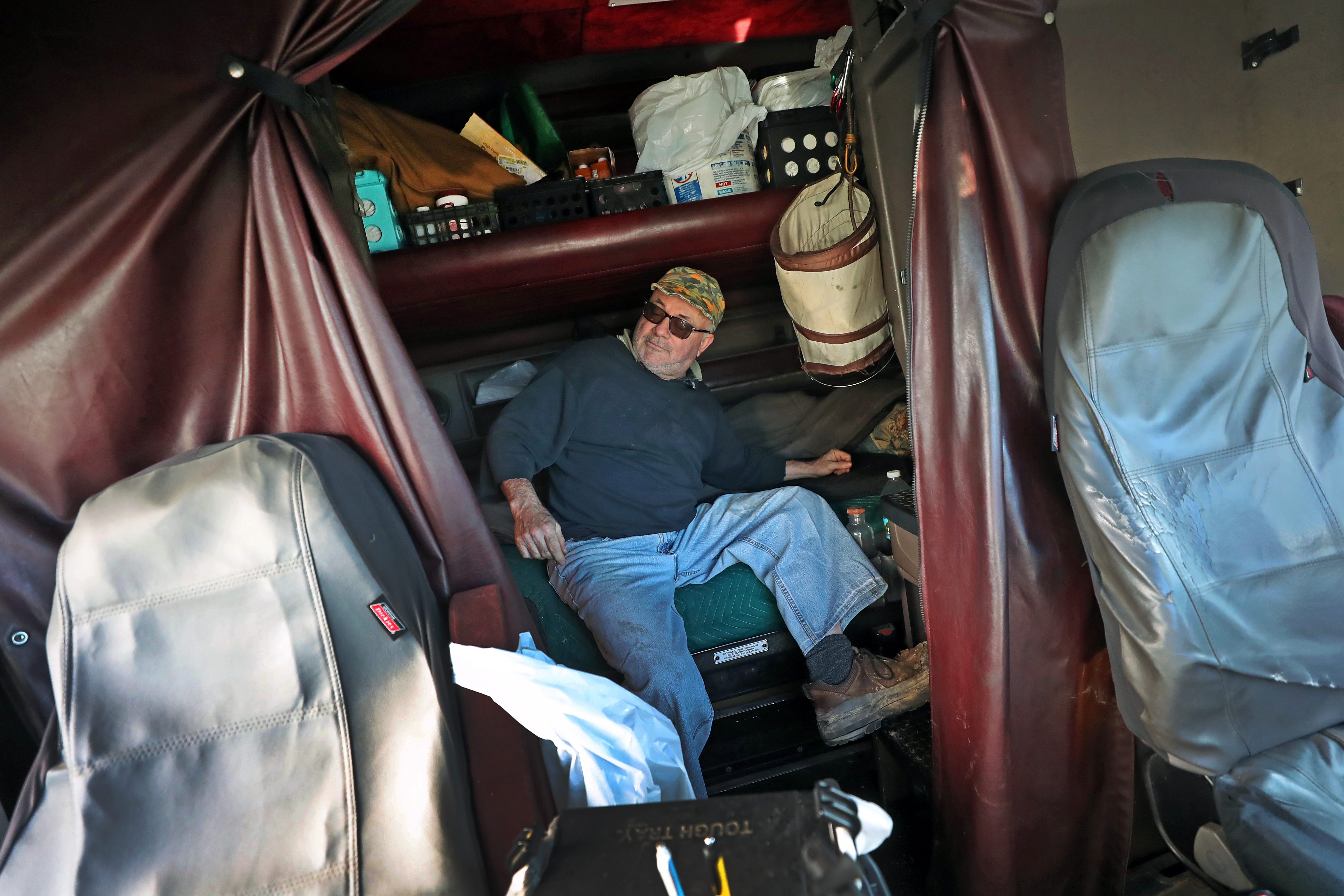 Robert Carroll in the cab of his truck, which has been his home on the road for more than 28 years.