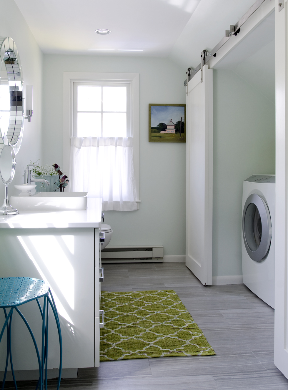 A fiberglass shower unit was originally wedged under the sloped ceiling. Swanson swapped it for a washer and dryer, which can be concealed by sliding doors.