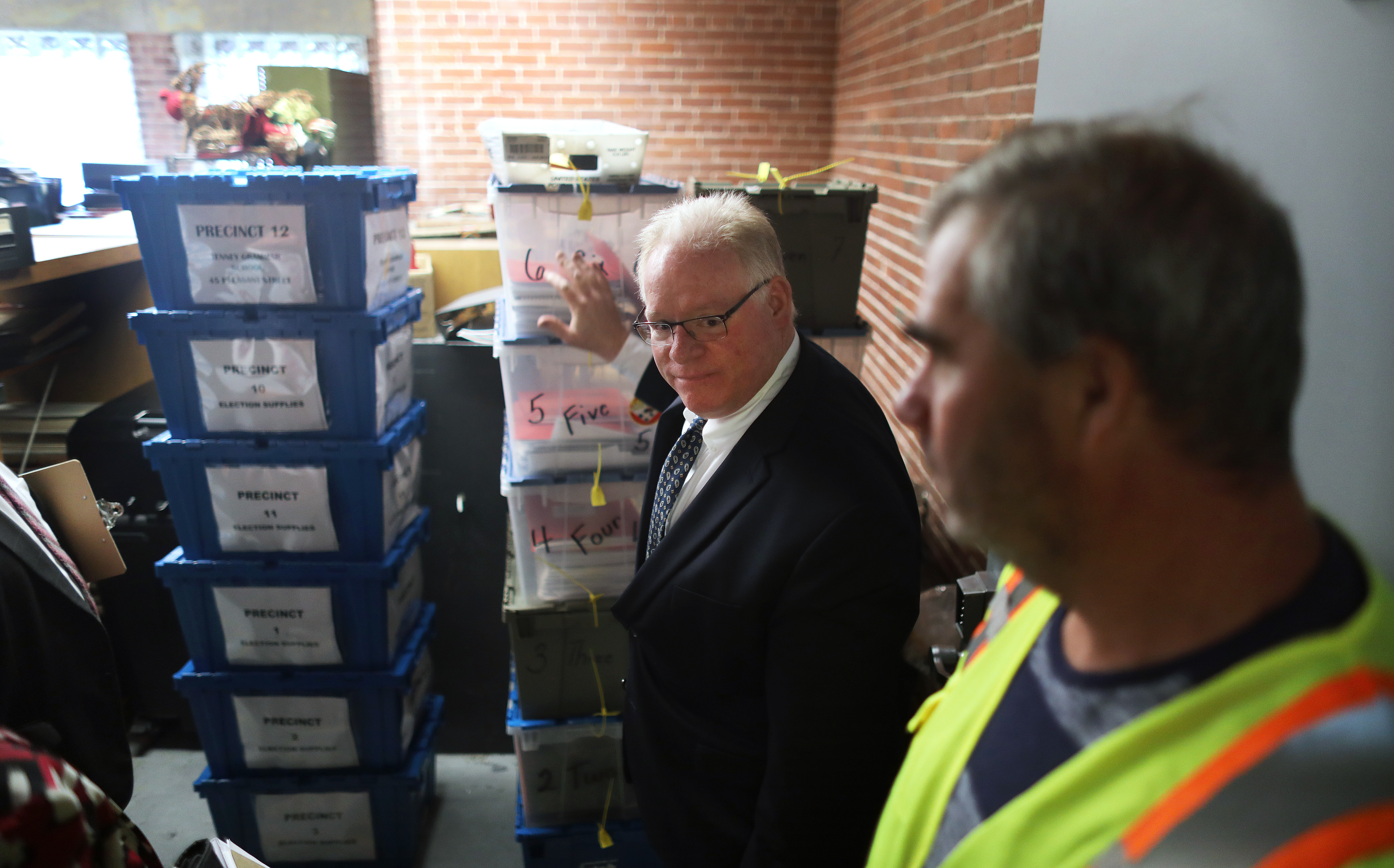 After opening the vault, Acting City Clerk John J. Wilson Jr. directed the removal of the sealed ballots.