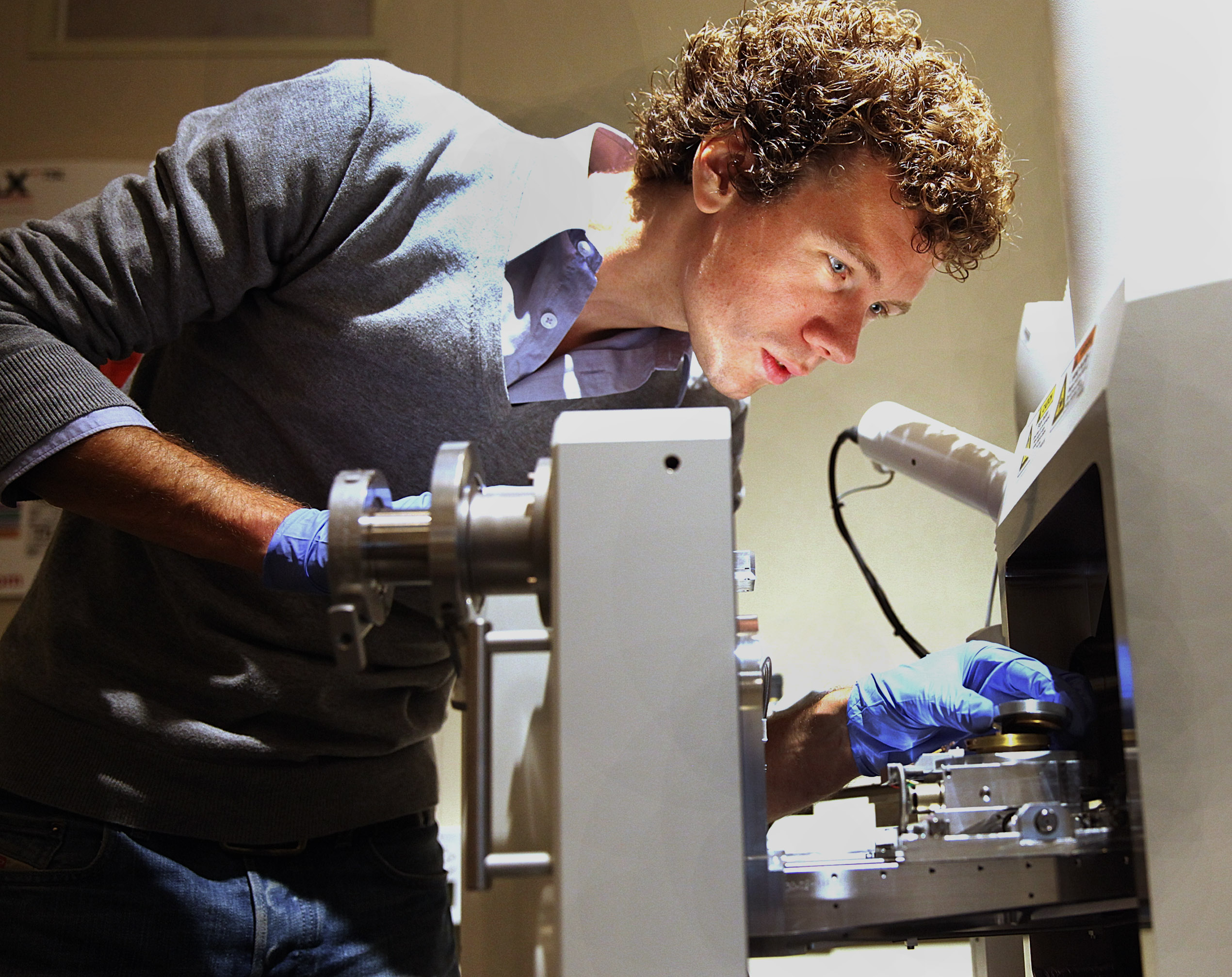 Wim Noorduin, a researcher at Harvard who grew the flower-like crystals featured in the journal Science, placed a sample of crystals in an electron microscope Thursday.