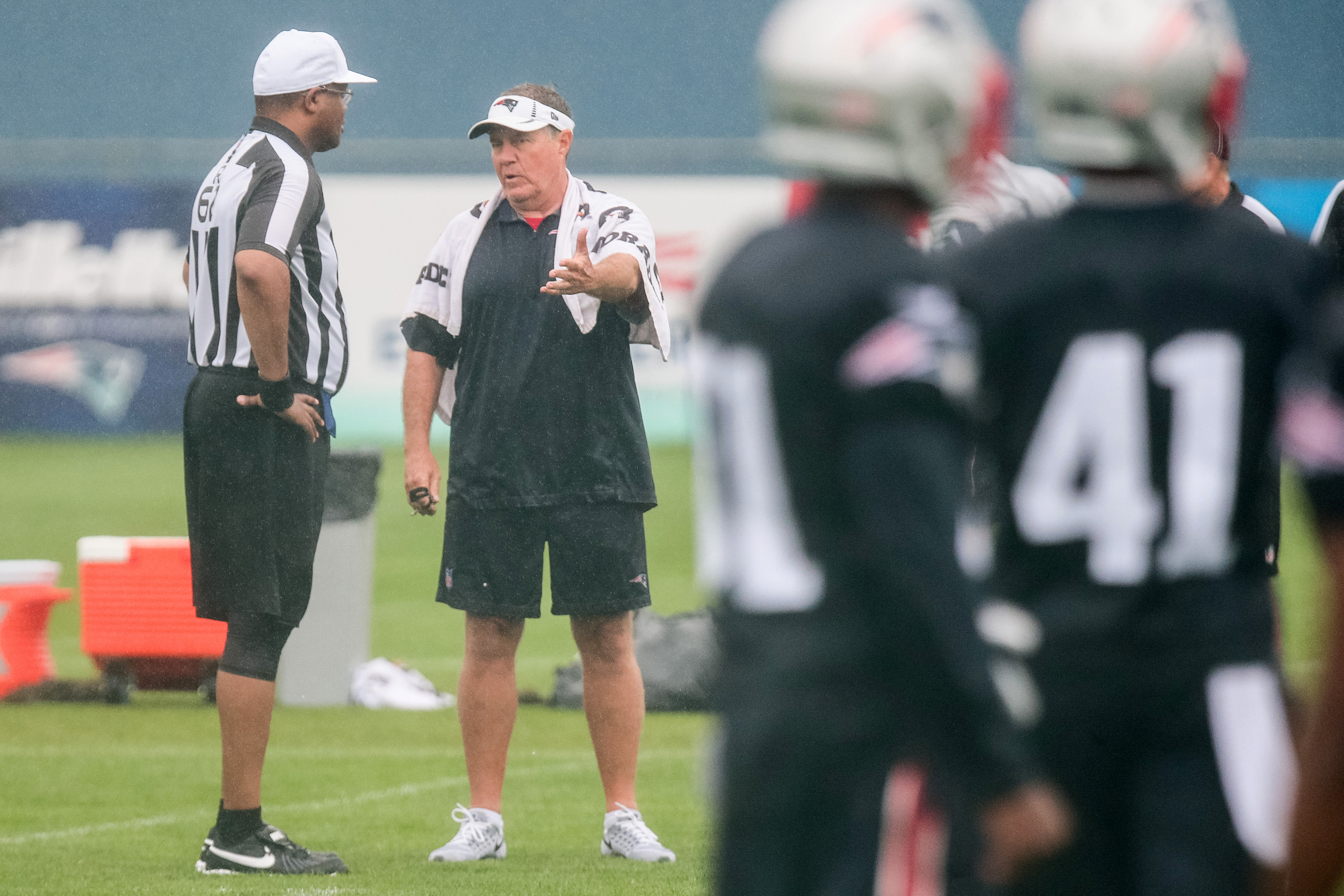 Ron Torbert and Bill Belichick chatted during a rainy joint practice with the Saints.