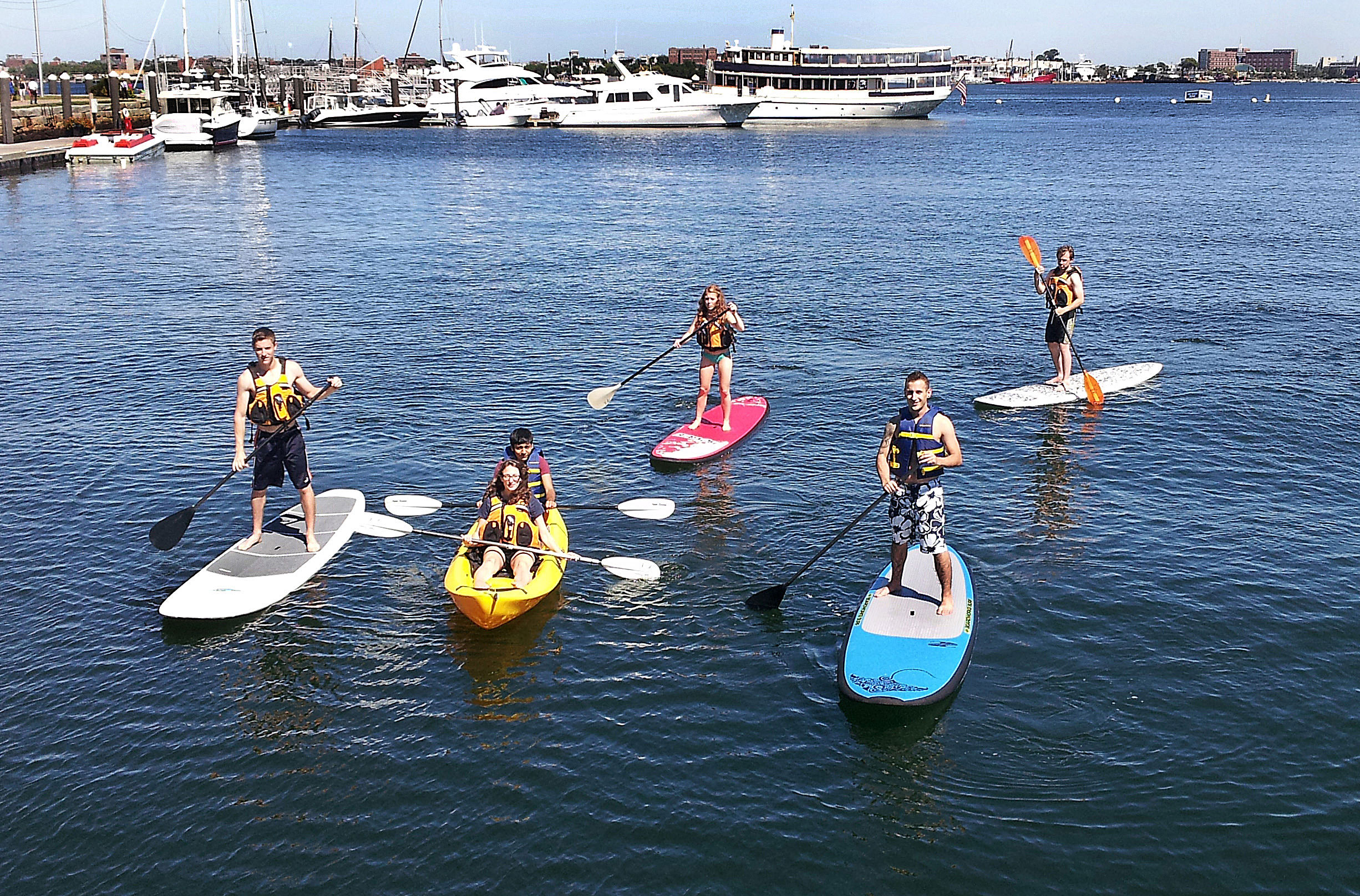 EnerNOC employees paddle on Boston Harbor.