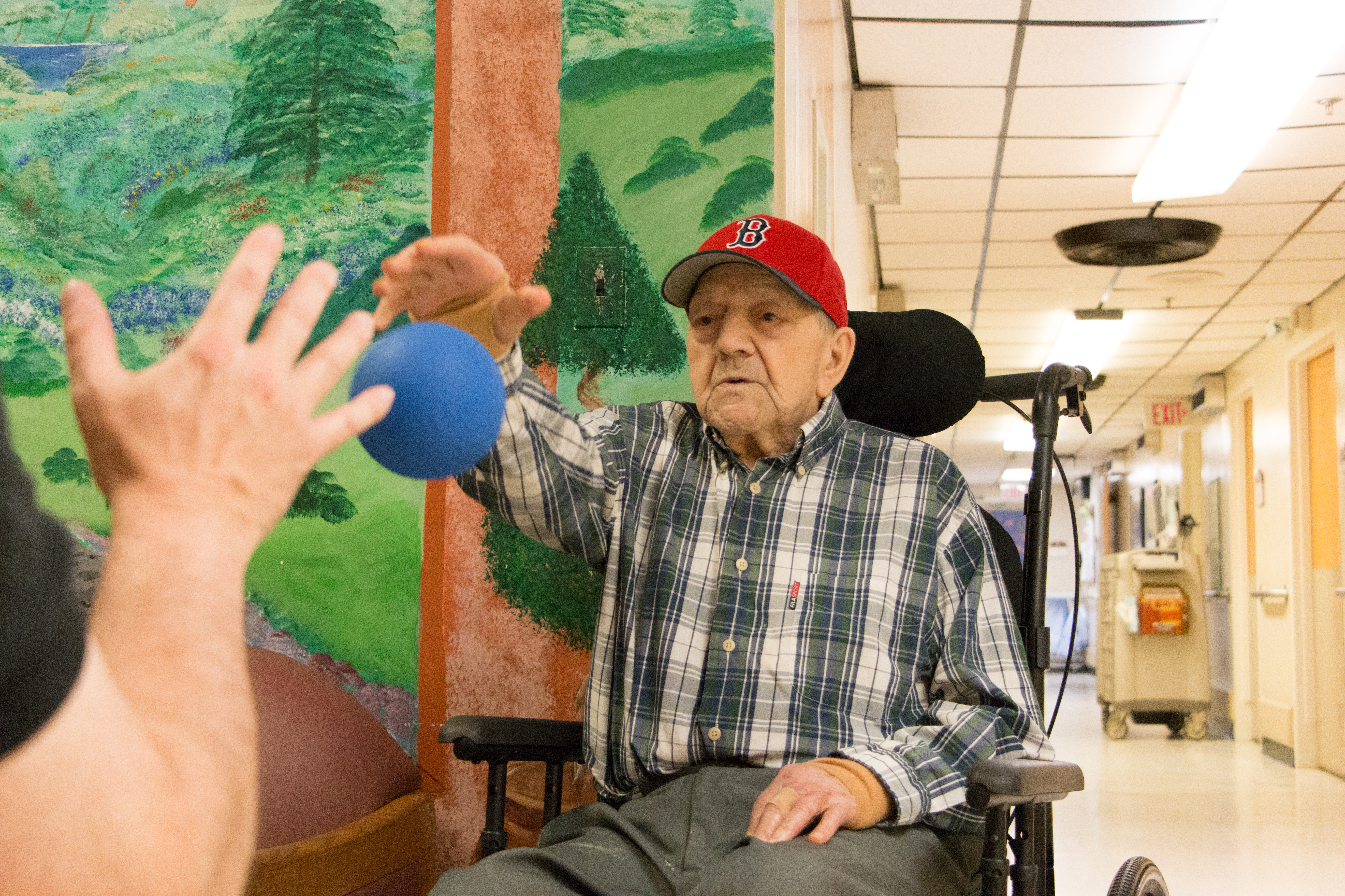 Nick visits his father several times a week to push him around the building in his wheelchair along with throwing a ball around.