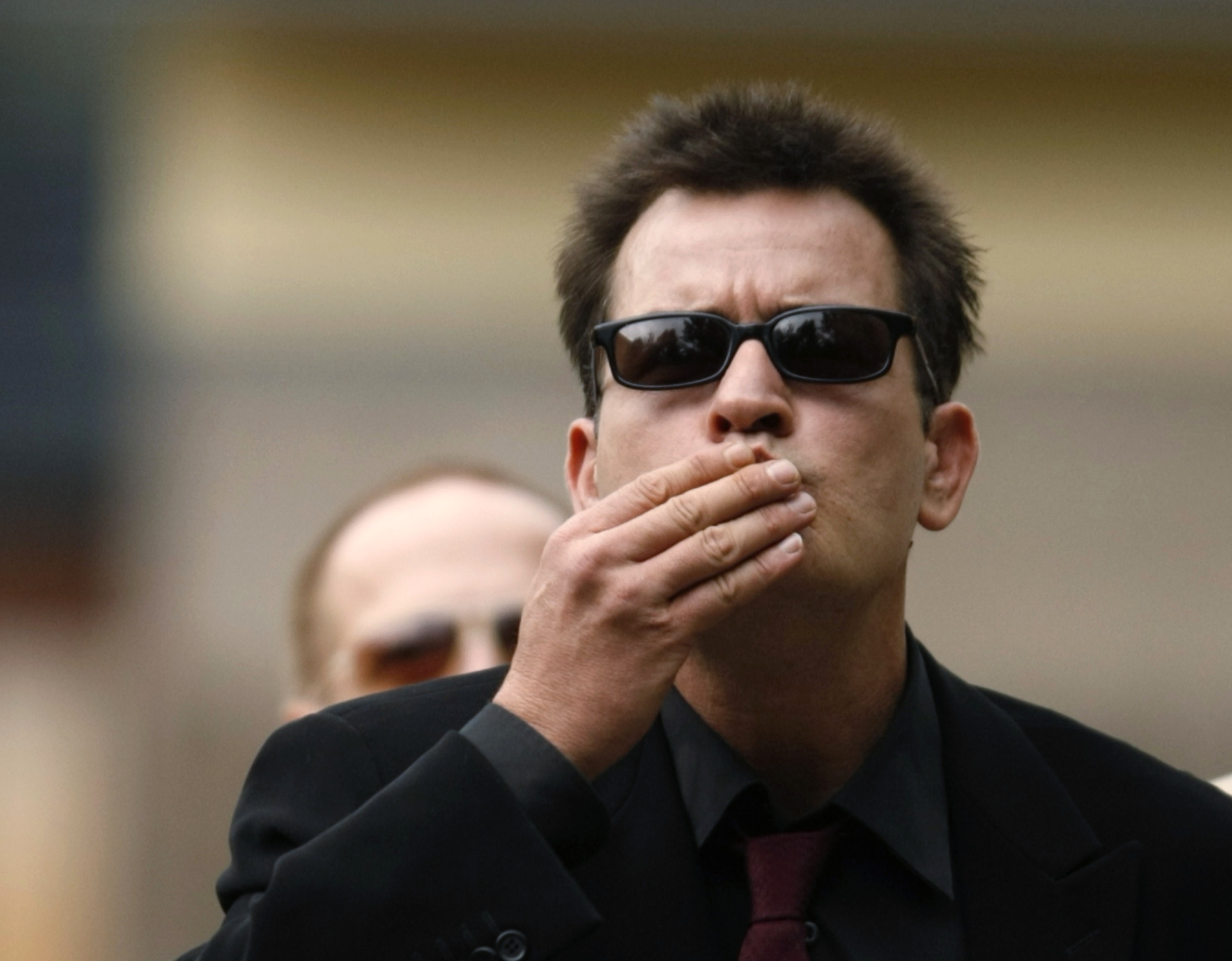 Winning: Actor Charlie Sheen greeted fans as he arrived at a Colorado courthouse.