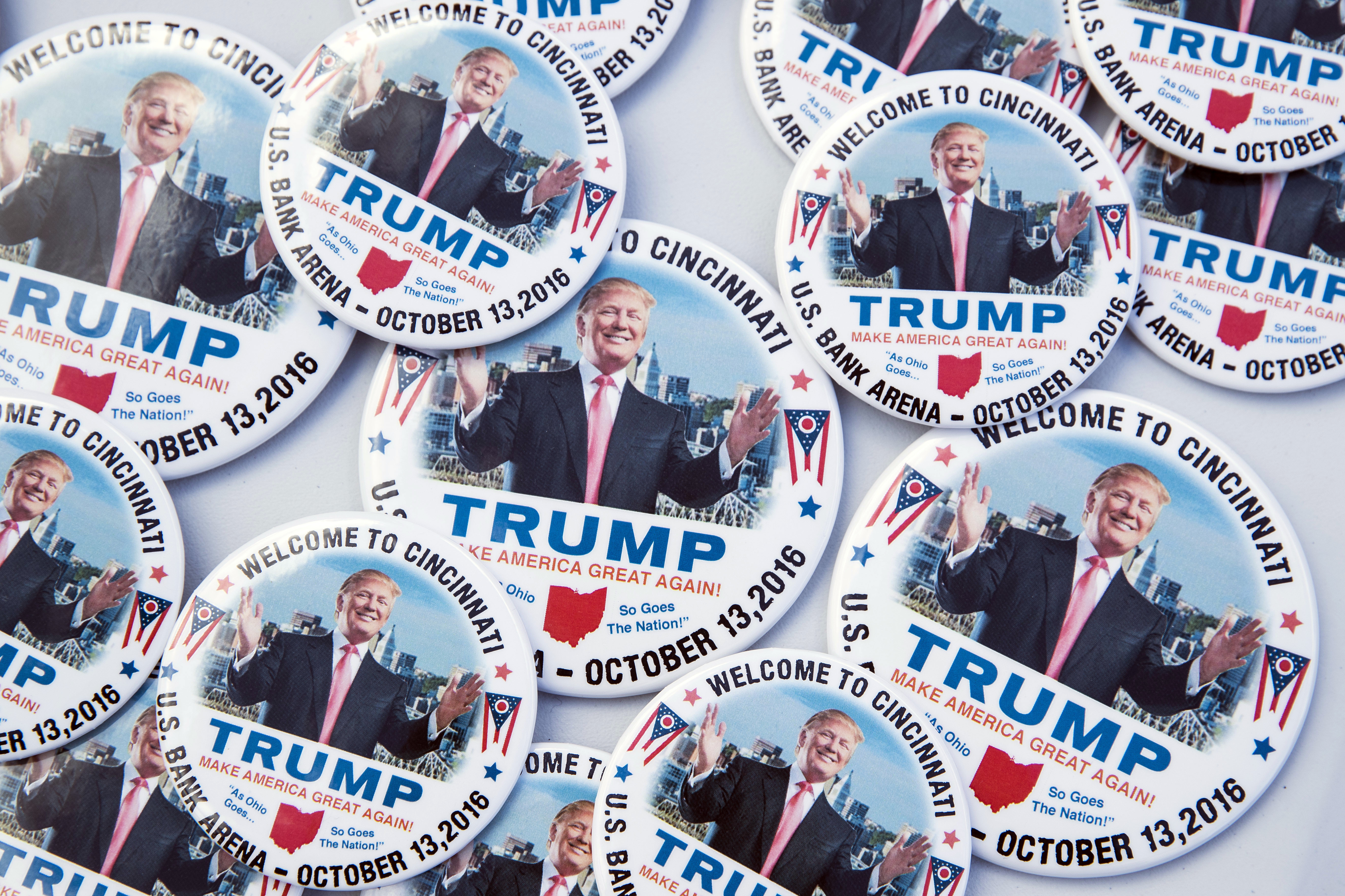 Campaign buttons in support of Republican presidential candidate Donald Trump rest on a vendor table before a campaign rally in Cincinnati on Thursday.