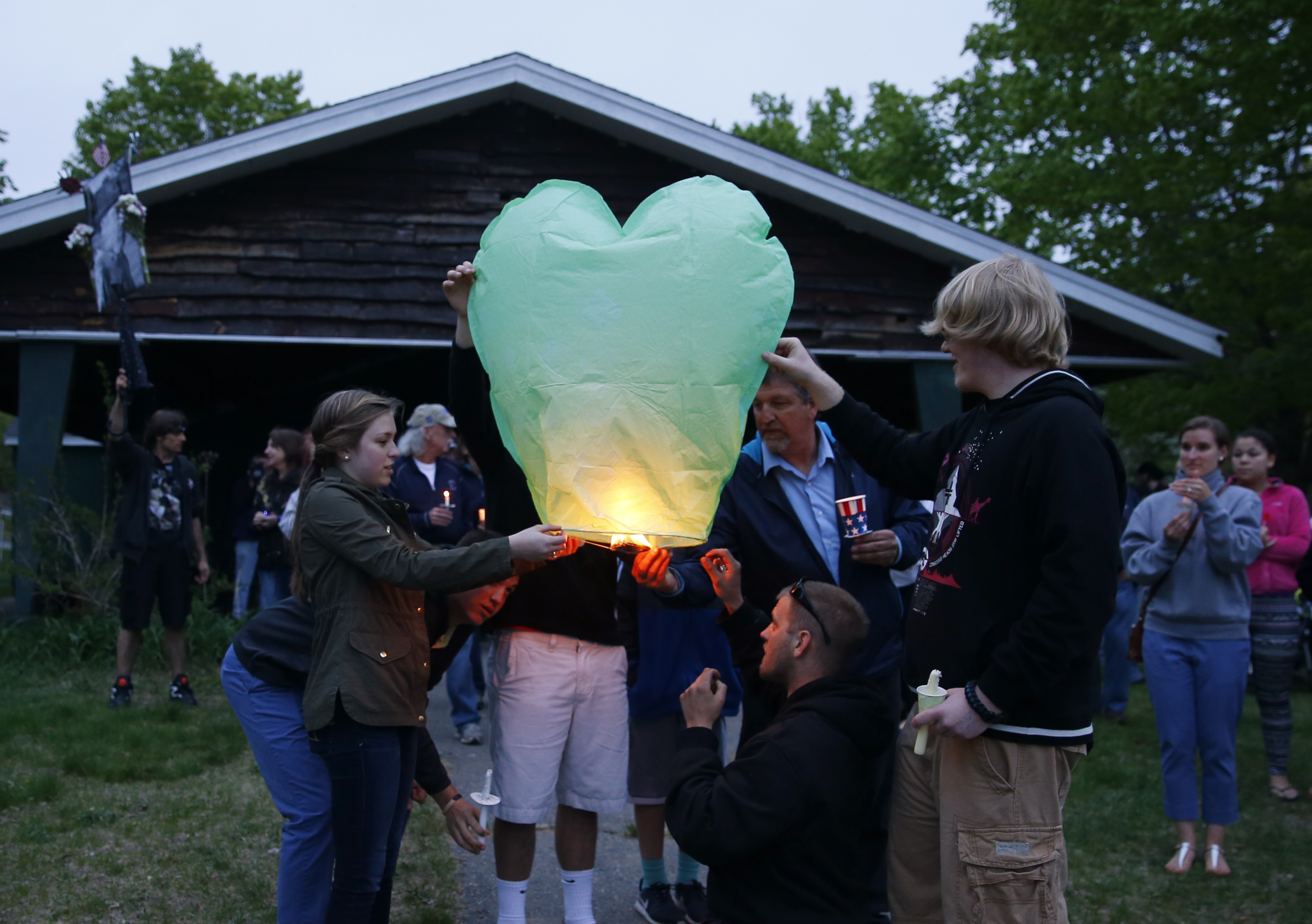 Family members sent up a lantern at a candlelight vigil for Mike Nicoloro in Haverhill on Monday.