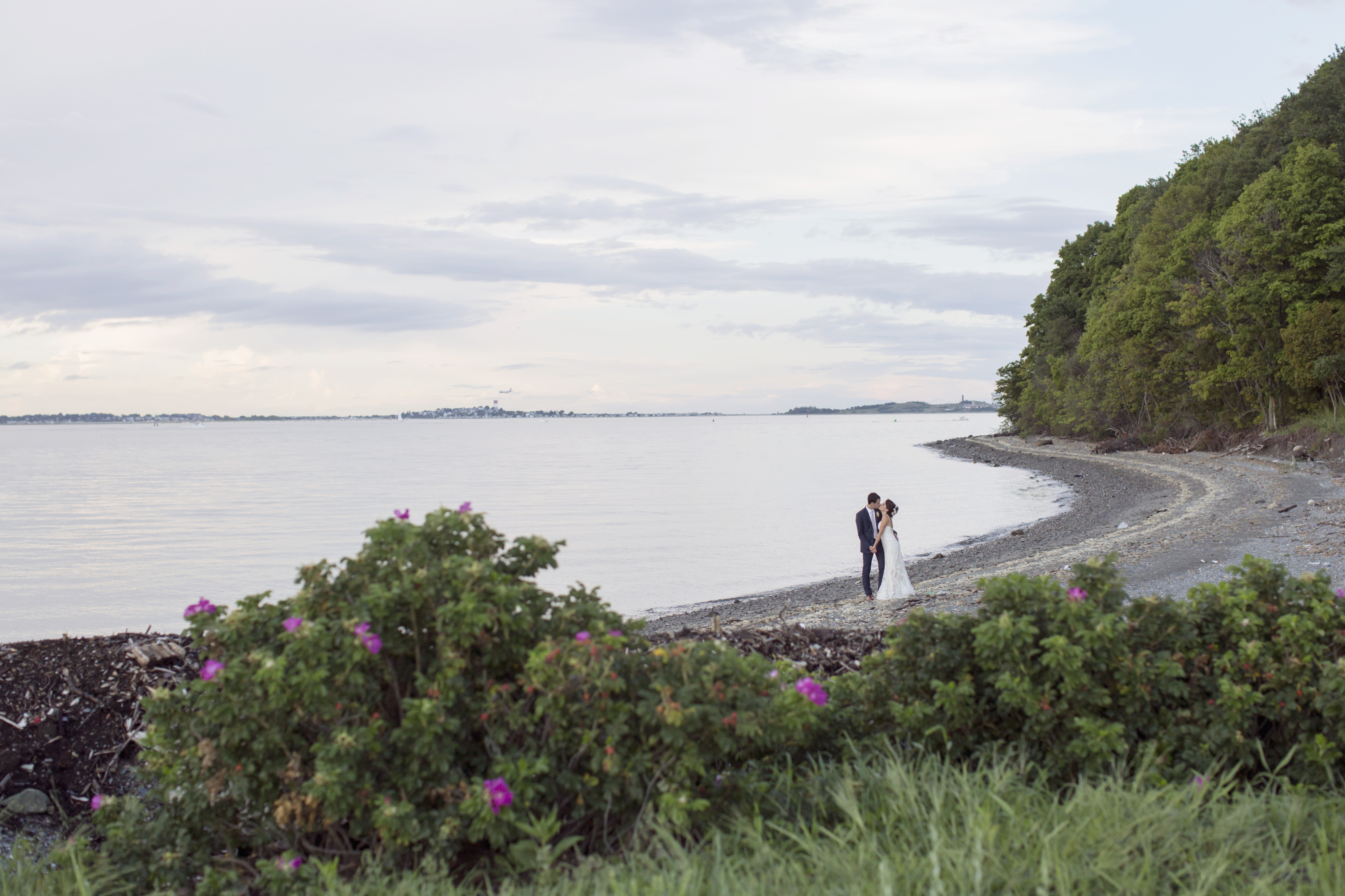 A couple embraces along the shoreline on Thompson Island.